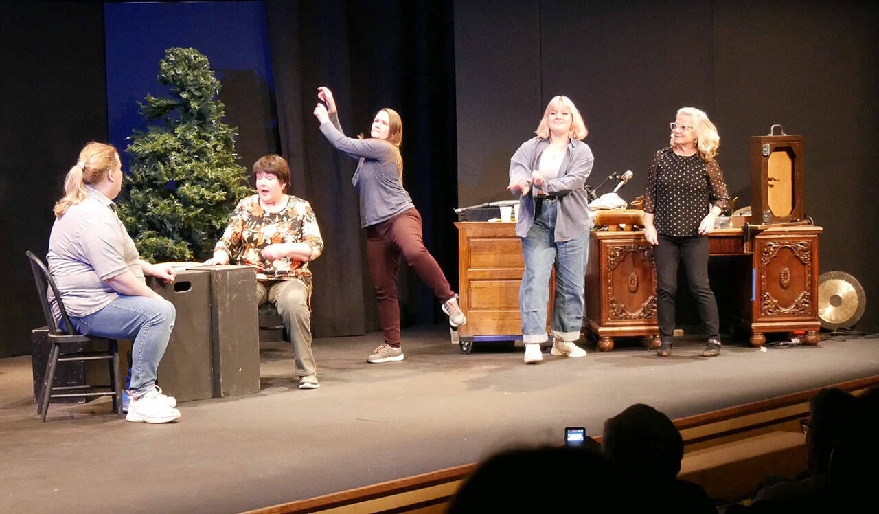 Andrejs Zommers, left, Nancy Peterson, Michelle Allen, Rose Weaver and Marybeth Redmond, members of the Imagined Reality Improv troupe, spontaneously perform on Olympic Theatre Arts’ partially built Christmas Carol set on the main stage in November. Not pictured is Tyler Weaver. (Photo courtesy of Olympic Theatre Art)