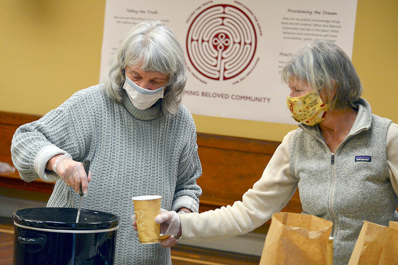 Marny Friedman, left, and Christine Emmes are part of the Just Soup crew each Tuesday at St. Paul’s Episcopal Church, where free hot lunches are handed out in the church parking lot. (Diane Urbani de la Paz/Peninsula Daily News)