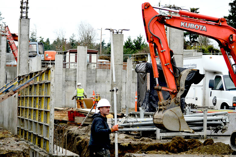 Jaymon Skinner of Bernt Ericsen Excavating is part of the crew moving earth for the foundation of 7th Haven, the Olympic Community Action Programs’ housing project at Seventh and Hendricks streets in Port Townsend. (Diane Urbani de la Paz/Peninsula Daily News)