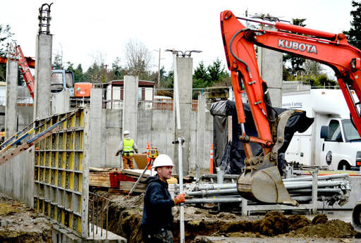 Jaymon Skinner of Bernt Ericsen Excavating is part of the crew moving earth for the foundation of 7th Haven, the Olympic Community Action Programs’ housing project at Seventh and Hendricks streets in Port Townsend. (Diane Urbani de la Paz/Peninsula Daily News)