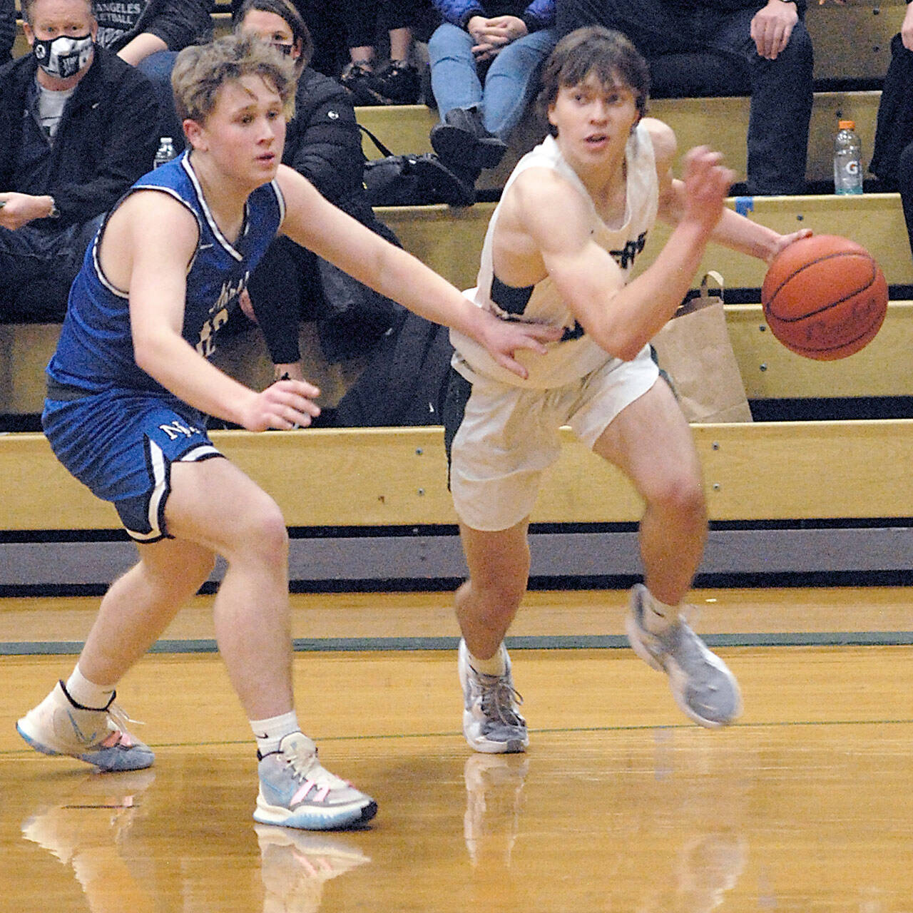 Keith Thorpe/Peninsula Daily News Port Angeles’ Parker Nickerson, right, outpaces North Mason’s Clay Alverts in Port Angeles’ last home game in December.