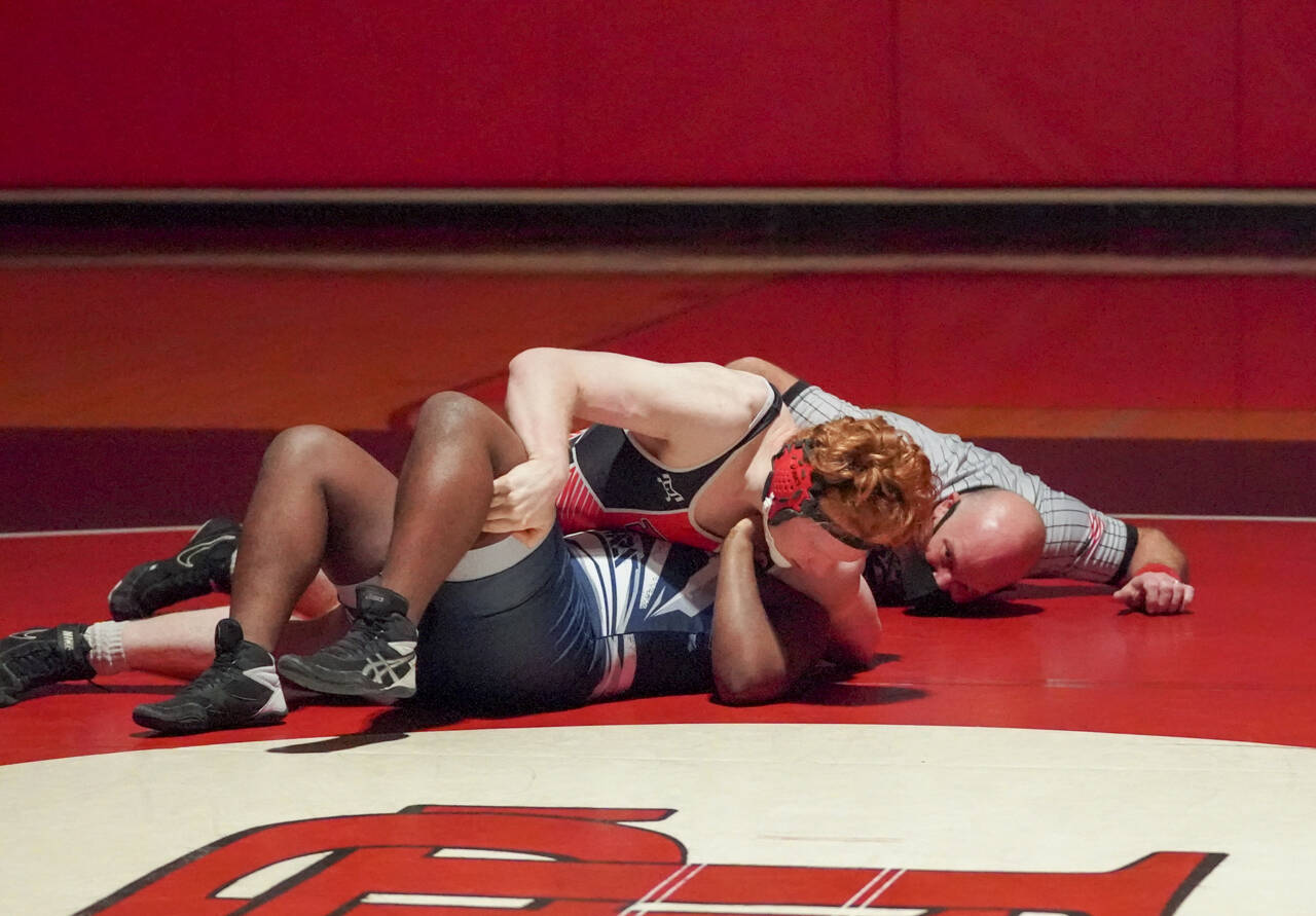 East Jefferson senior Gage Berry, top, pins Cascade Christian’s Aphelele Mzameko in the 182-pound weight class during the Rivals’ senior night victory over the Cougars on Wednesday at Port Townsend High School. (Steve Mullensky/for Peninsula Daily News)