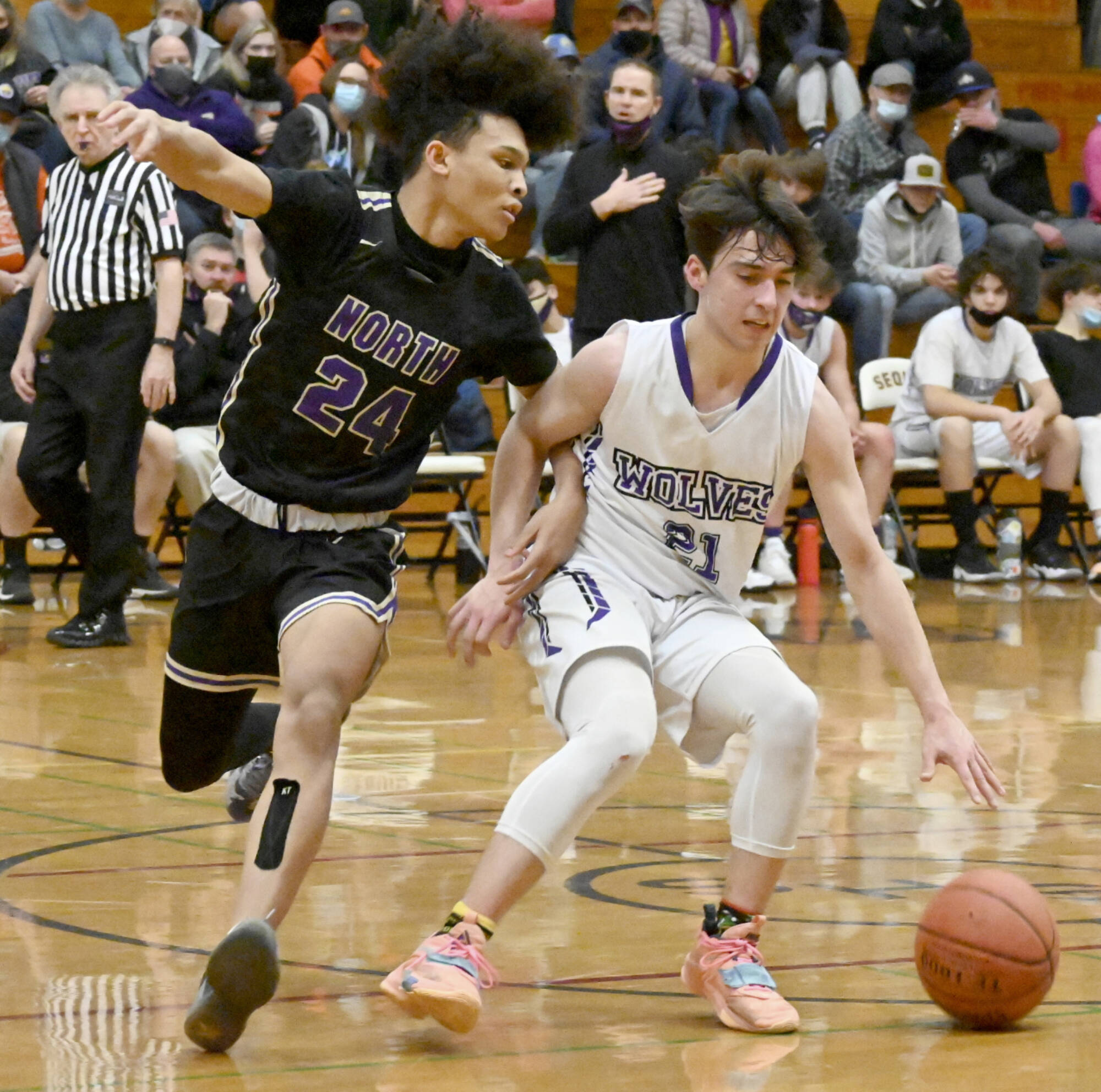 Sequim's Jaydin Possin (21) dribbles against the defense of North Kitsap's Jalen East on Thursday in Sequim. (Michael Dashiell/Olympic Peninsula News Group)