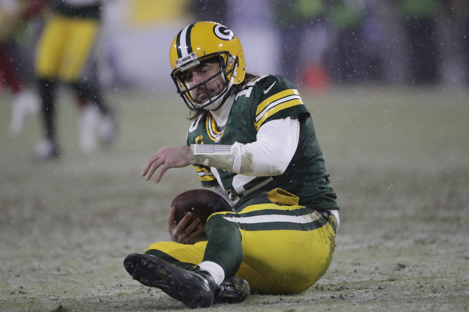 Green Bay Packers Aaron Rodgers reacts after being sacked by San Francisco 49ers Arik Armstead during the second half of an NFC divisional playoff NFL football game Saturday, Jan. 22, 2022, in Green Bay, Wis. (AP Photo/Aaron Gash)