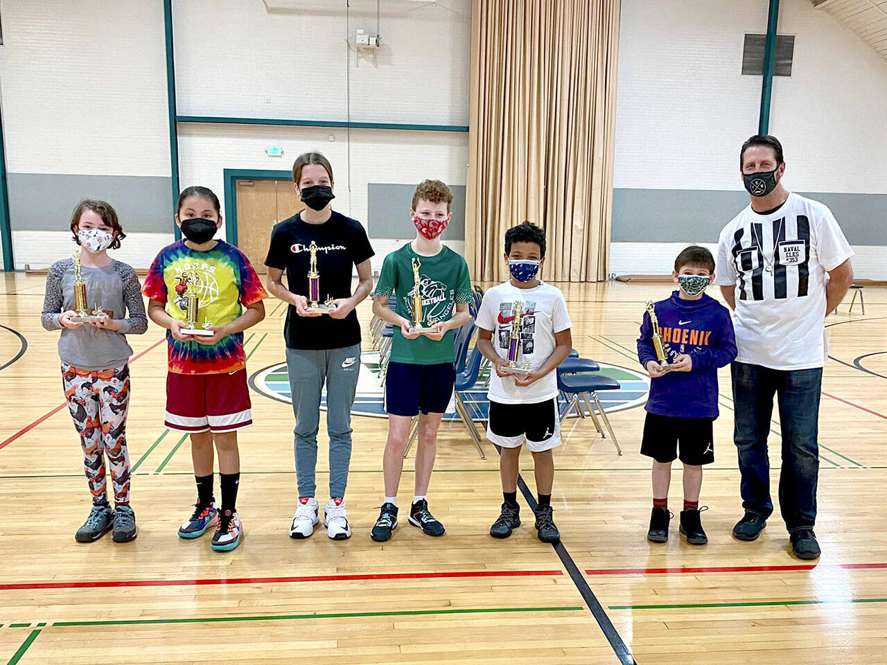 Port Angeles Naval Elks Lodge Hoopshoot winners advancing to the district finals are from left, Quinn Herr, Skylar Wheeler, Morgan Politika, Sawyer Davis, Makai McAfee, Jude Sprague and event coordinator Evan Boyd. The district finals will be held at the Vern Burton Community Center with registration beginning at noon. Hoopshoot is an annual basketball free-throw shooting contest for children ages eight to 13 across the country. (Courtesy photo)