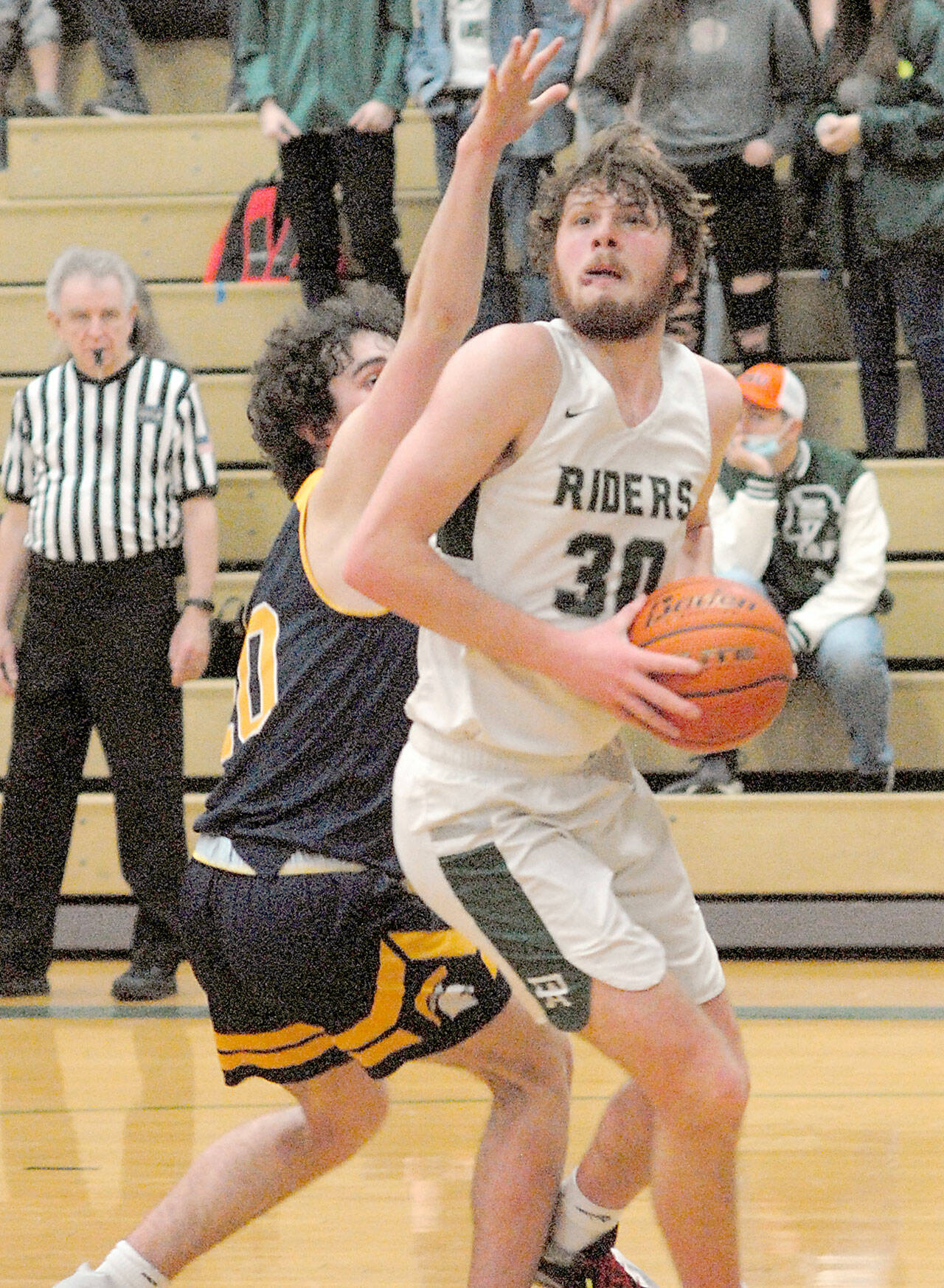 Port Angeles’ Wyatt Dunning, right, looks for an opening as he holds off the defense of Bainbridge Island’s Ben Nylund on Tuesday in Port Angeles. (Keith Thorpe/Peninsula Daily News)