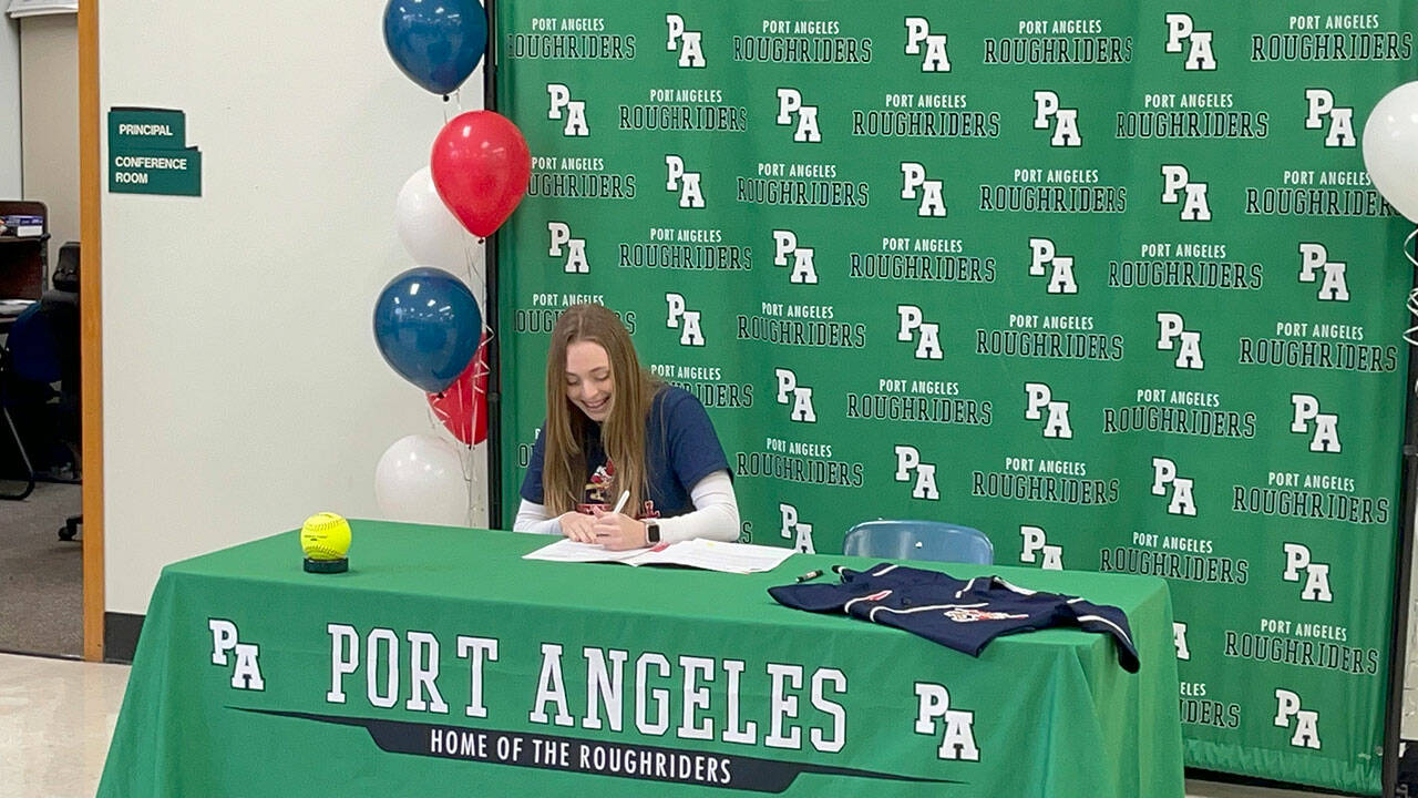 Port Angeles senior Teagan Clark signs a letter of intent to play softball for Skagit Valley College during a signing ceremony Tuesday at the Port Angeles High School Student Center.