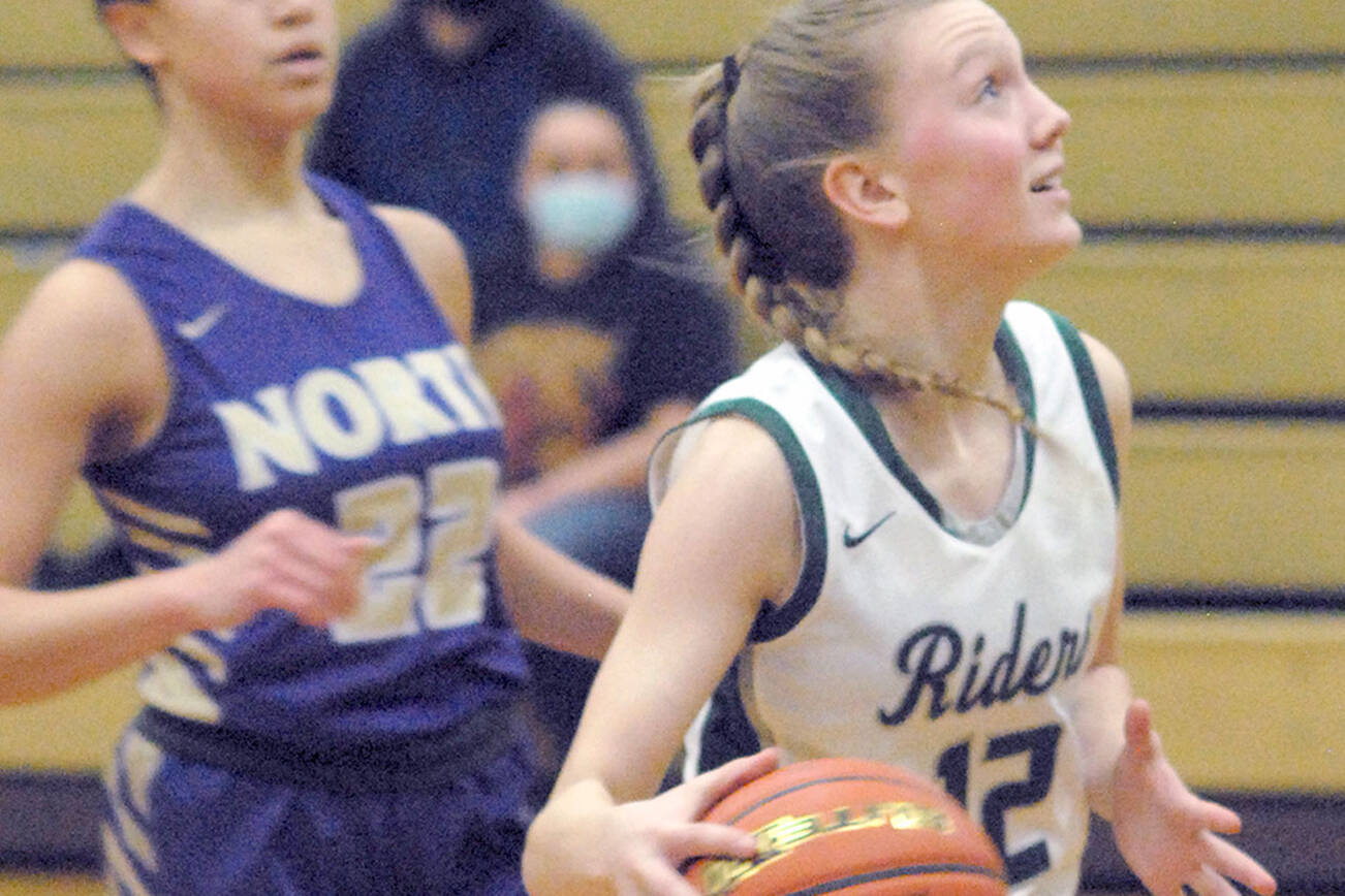 Keith Thorpe/Peninsula Daily News
Port Angeles' Isabelle Felton, right, sets her sights on the hoop while chased by North Kitsap's Ayanna Selembo on Thursday in Port Angeles.
