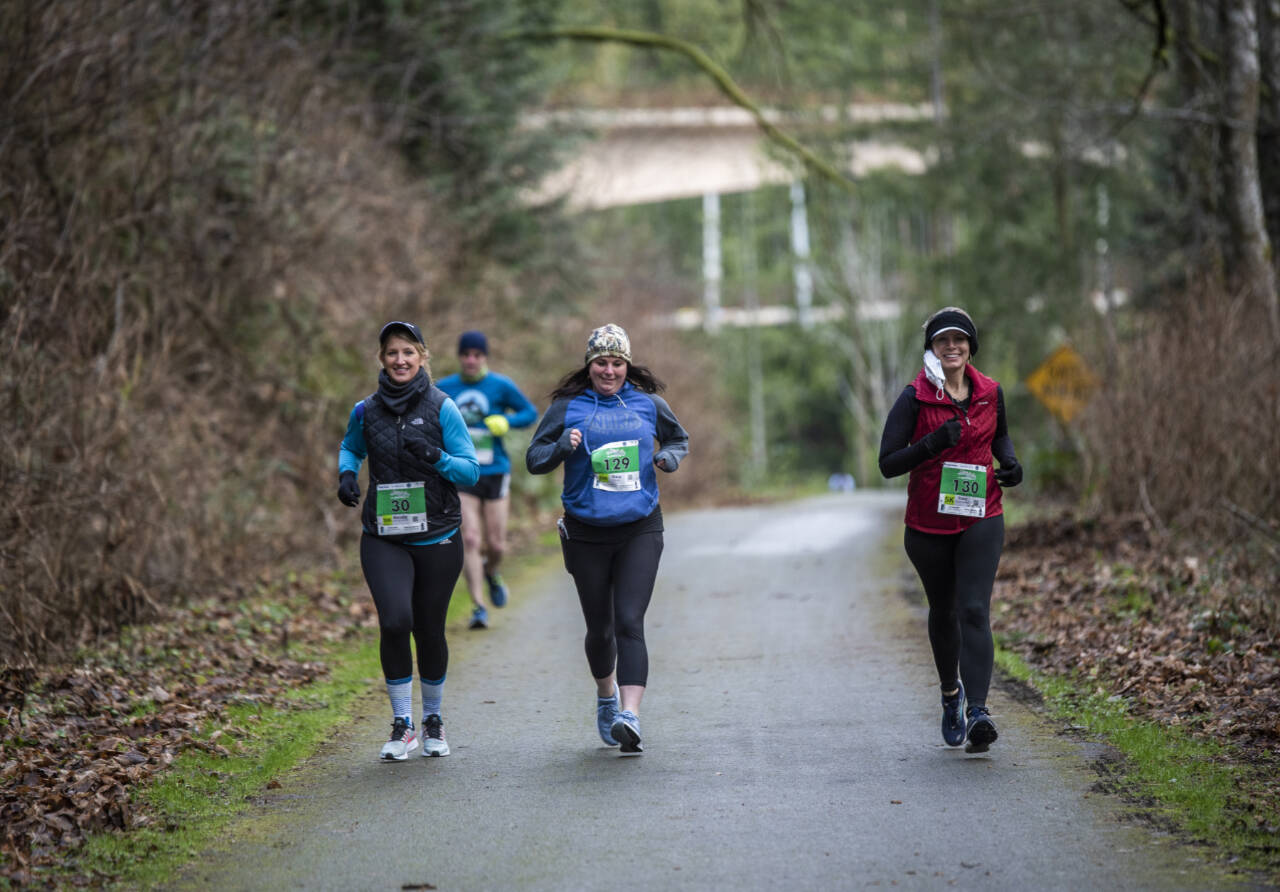 Courtesy of Run the Peninsula From left, Nicole Heckenlaible, Stacy Flores and Stacy Braithwaite all run in the Elwha Bridge Run in 2021. The race returns Saturday as the initial event of the Run the Peninsula series.
