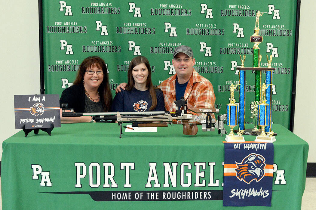 Port Angeles Cheyenne Maggard, center, is joined by her parents Meghan and Brent as she signs her letter of intent to compete in air rifle at the University of Tennessee-Martin. (Carmen Geyer/Port Angeles School District)