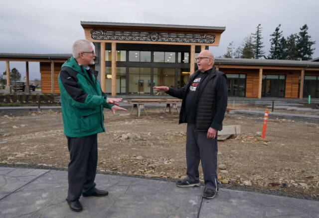 W. Ron Allen, right, chairman of the Jamestown SKlallam Tribe, talks with Brent Simcosky, left, tribal health director, Wednesday, Feb. 2, 2022, in front of the Jamestown Healing Clinic, in Sequim, Wash. The tribe is building a full-service health center to treat both tribal members and other community residents for opioid addictions. Earlier in the week, Native American tribes across the U.S. settled a lawsuit against drug maker Johnson & Johnson and the largest three drug distribution companies in the U.S. for $590 million. The money wont be distributed quickly, but tribal leaders say it will play a part in healing their communities from an epidemic that has disproportionately killed Native Americans. (AP Photo/Ted S. Warren)