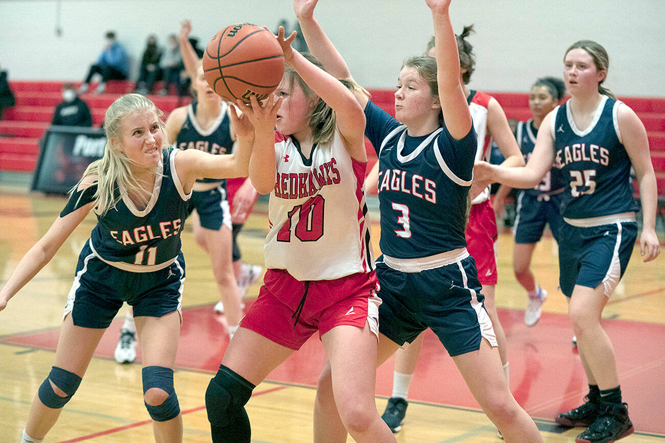 Steve Mullensky/for Peninsula Daily News

East Jefferson's Rennie ODonnell is defended by Life Christian Academy’s Betsy Lovrak (11) and Katie Kunitsa (3) during a make-up game in Port Townsend on Monday.