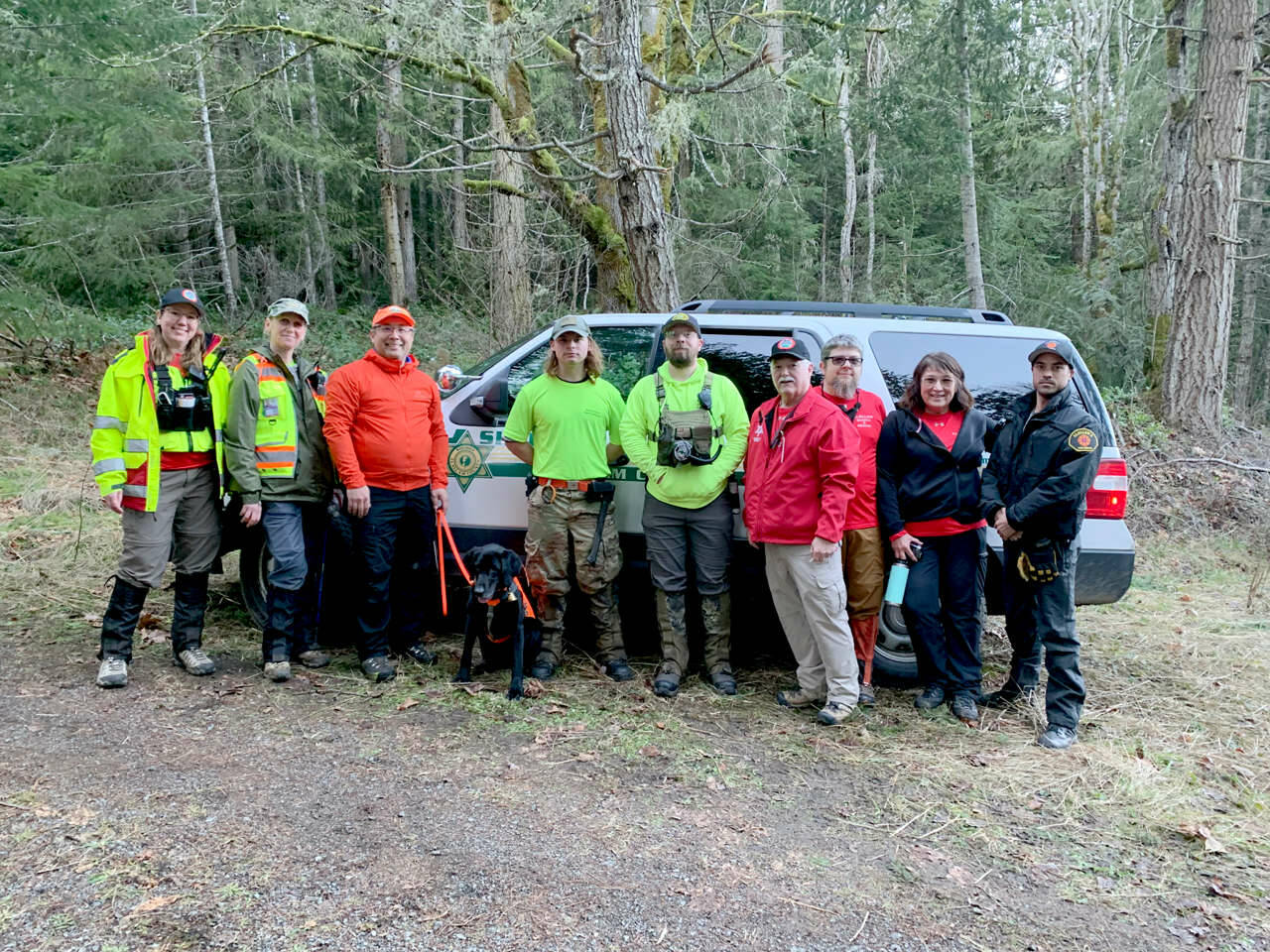 Searchers from Clallam and Mason counties who helped find Isaac Rivas on Saturday include, from left, Emily Last, T. Kenner, Chris Terpstra with his K-9 partner Makalu, Xenos Myers, Andrew Myers, Terry Shultz, Kurt Engel, Emma Janssen and Matt Aston. (Clallam County Sheriff’s Office)