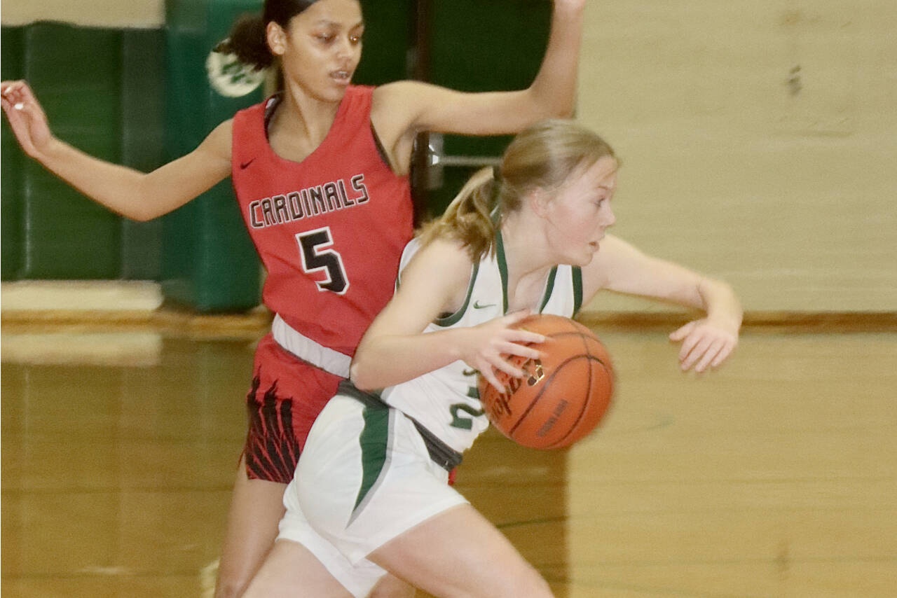 Port Angeles' Anna Petty drives around Franklin Pierce's Zionna Barbee (5) in the Roughriders' 73-28 district playoff win Tuesday night in Port Angeles. With the win, the Riders have already qualified for the state regional round. (Dave Logan/Peninsula Daily News)