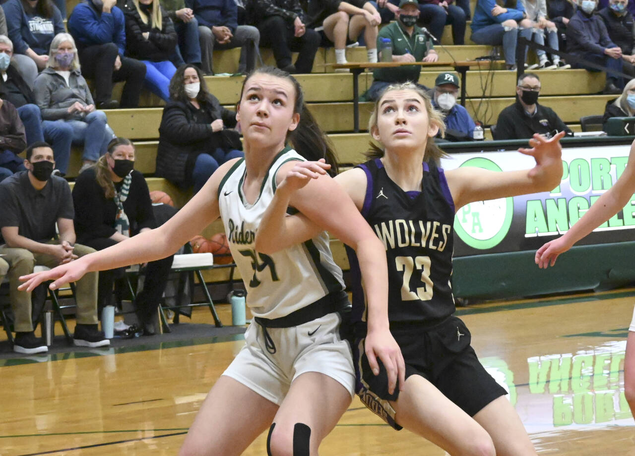 Port Angeles Lexie Smith, left and Sequims Lauryn Stephens battle for rebounding positions. (Michael Dashiell/Olympic Peninsula News Group)