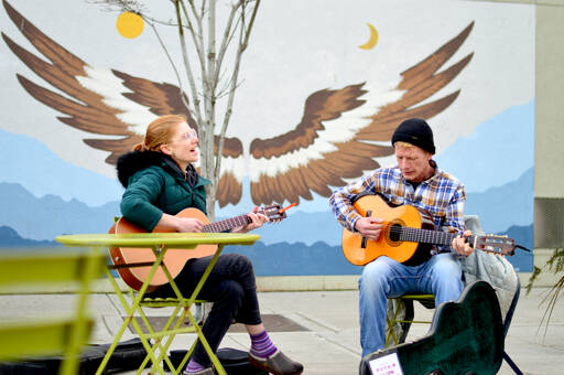 The local duo True Reckoning — AB McSpadden, left, and Tex Armstrong — play an acoustic set Friday afternoon at Tyler Street Plaza in downtown Port Townsend. The pair also performs at local clubs and plans to tour up Alaska’s Inside Passage this summer. (Diane Urbani de la Paz/Peninsula Daily News)
