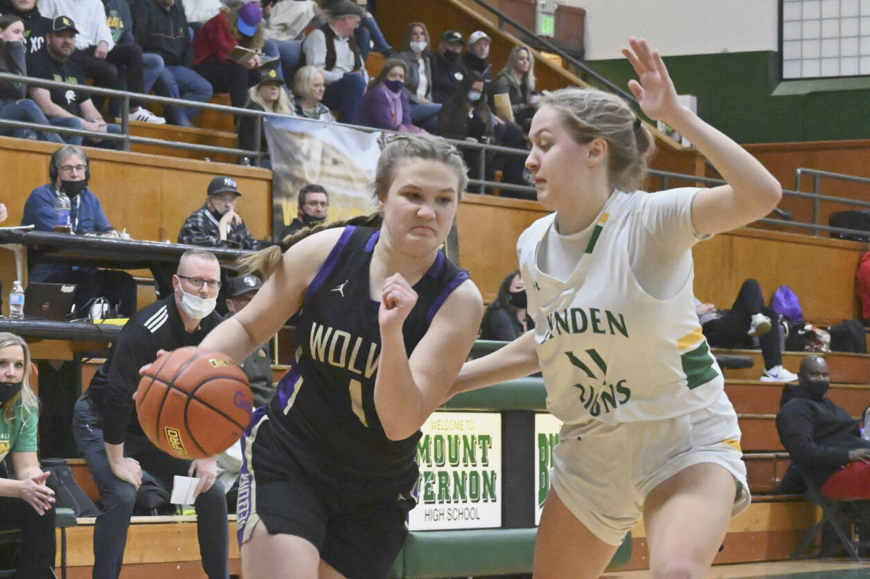 Sequim's Addie Smith drives around Lynden's Mallary Villars in the state 2A regional game held Friday night in Mount Vernon. (Michael Dashiell/Olympic Peninsula News Group)