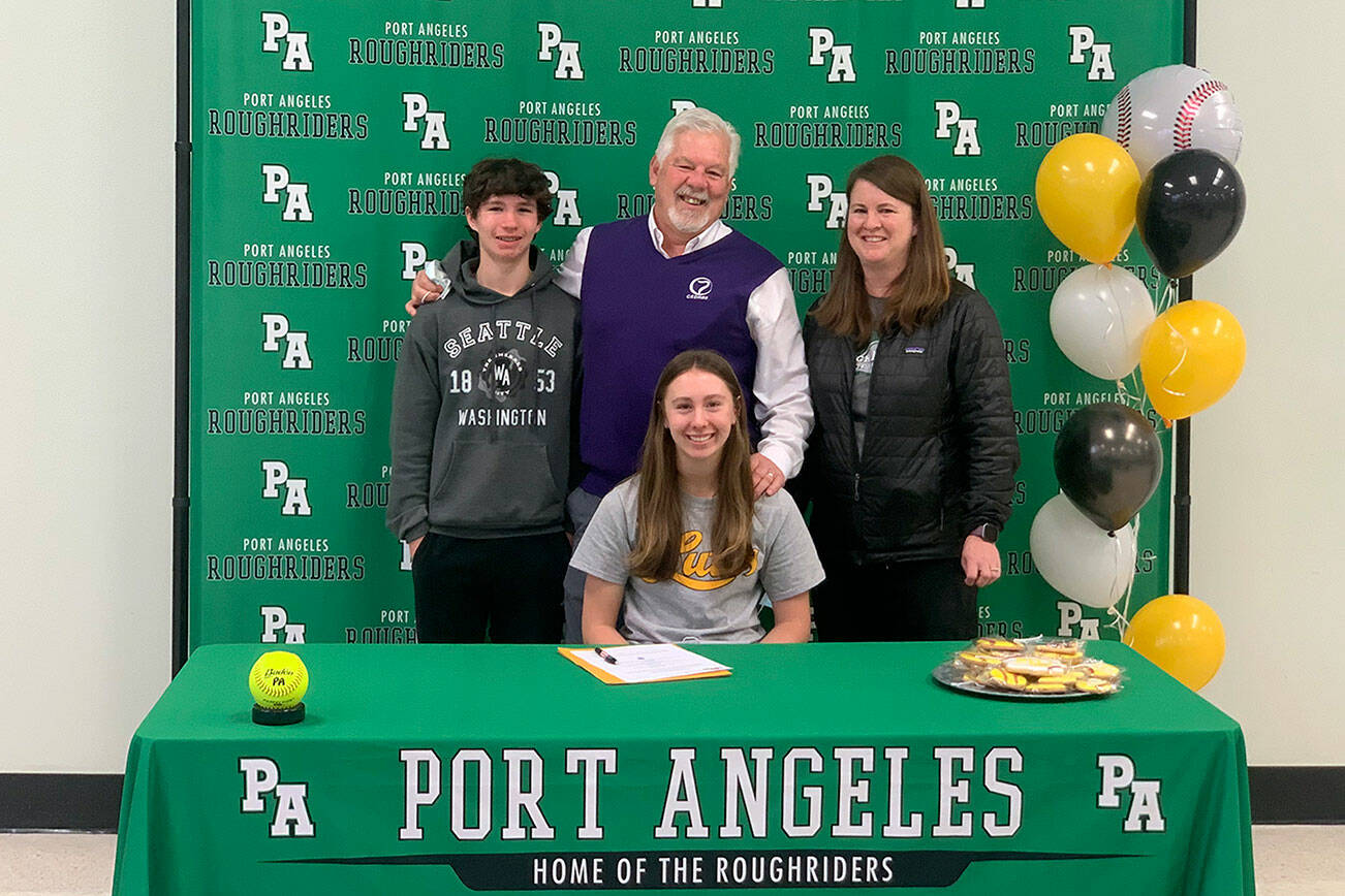 Port Angeles' Zoe Smithson, seated, recently signed a letter of intent to play softball at Pacific Lutheran University in Parkland. Smithson is joined by, from left by her brother Ian, dad Larry and mom Staci at her signing ceremony.