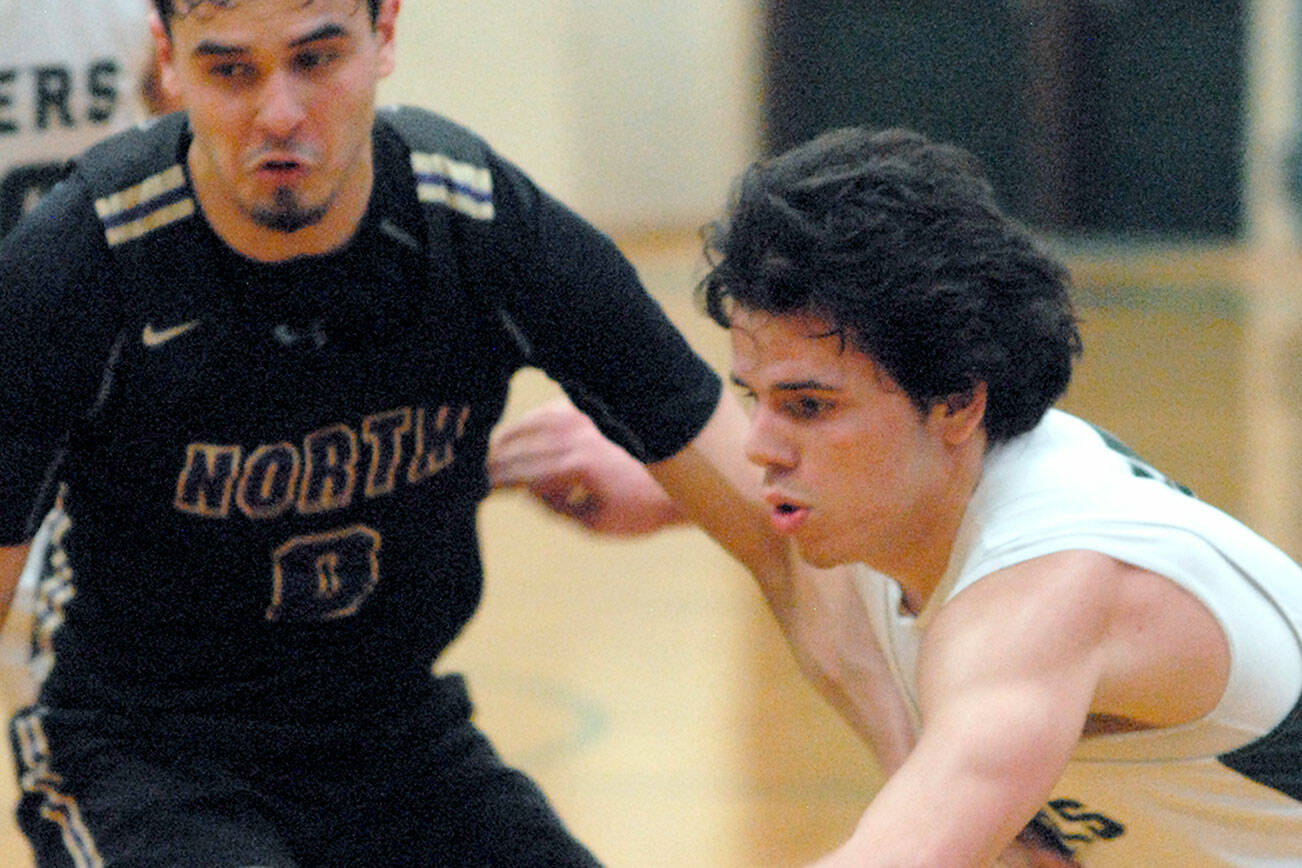 Keith Thorpe/Peninsula Daily News
Port Angeles' Xander Maestas, front, drives past North Kitsap's Johny Olmsted on Thursday night in Port Angeles.