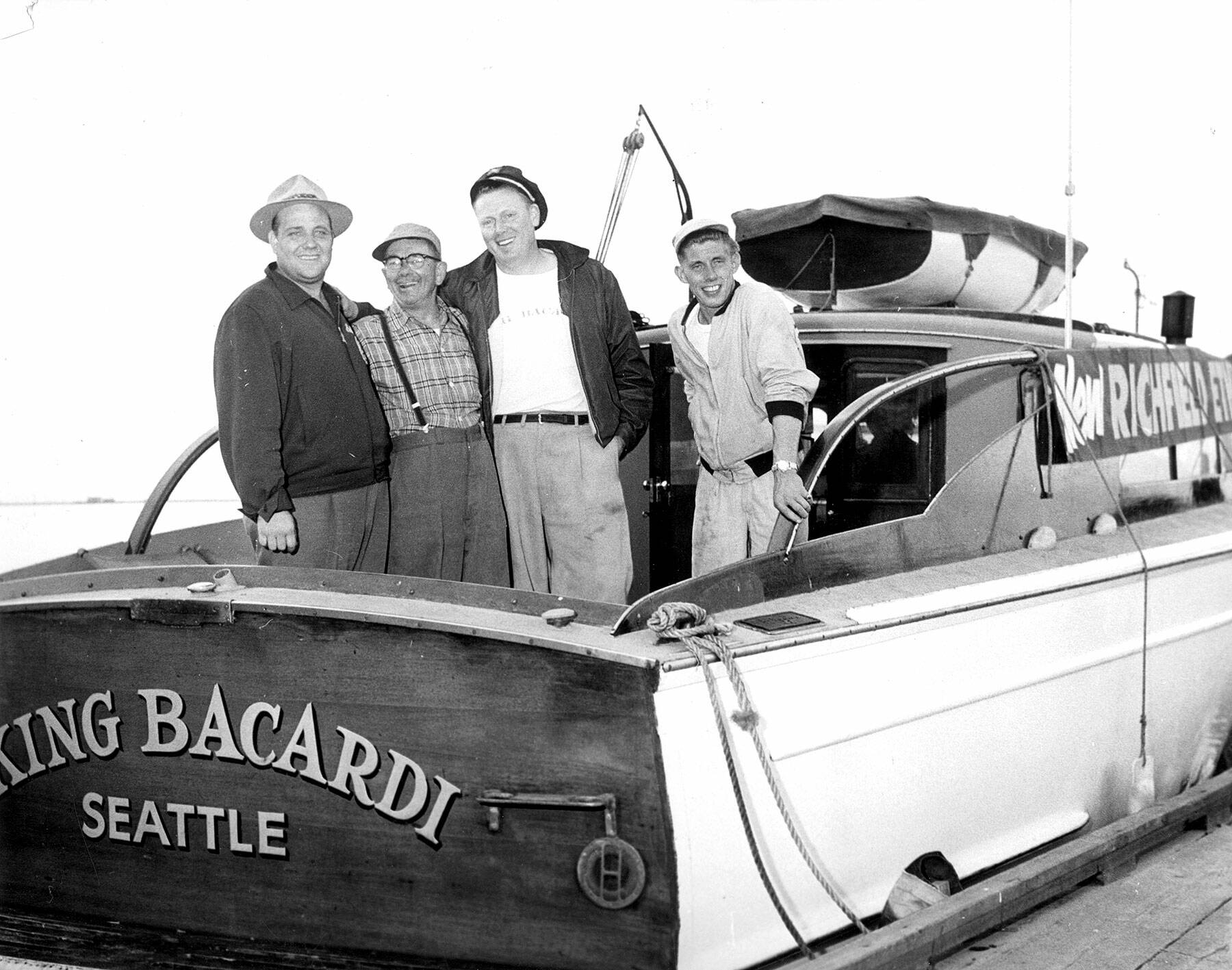 Long-distance swimmer Bert Thomas, far left, Bud Olsen, second from right, and the rest of his support team aboard the King Bacardi. (Courtesy of North Olympic History Center)