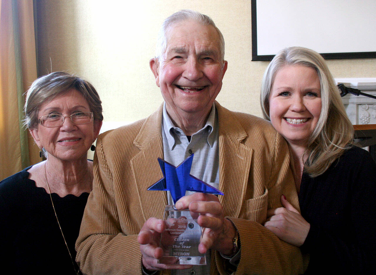 Myron Vogt, center, was honored in April 2019 by the Chamber of Jefferson County as its 2018 Citizen of the Year during a ceremony at the Old Alcohol Plant in Port Hadlock. He was joined by his wife, Valeria, left, and his daughter, Jennifer Molloy. (Brian McLean/Peninsula Daily News file)