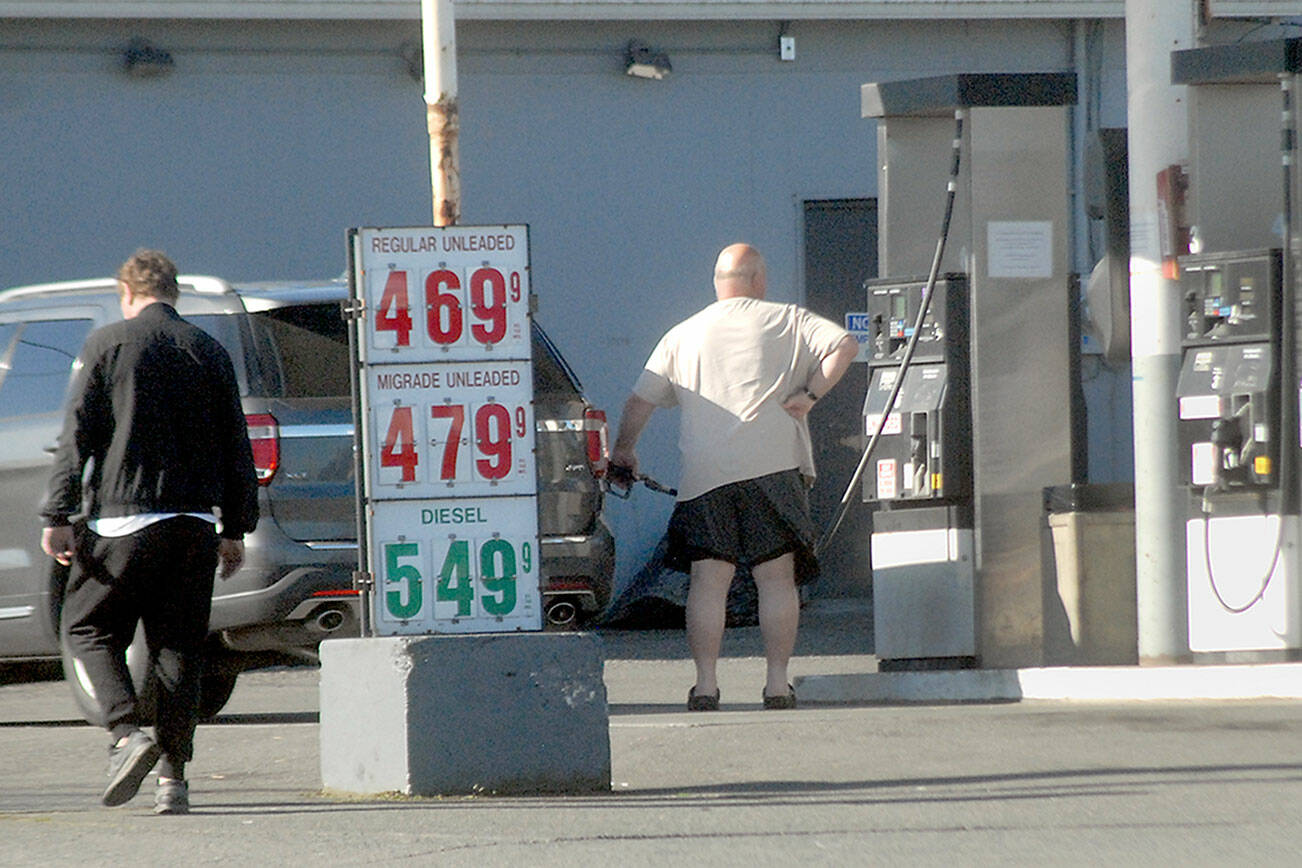 Keith Thorpe/Peninsula Daily News
A customer fills his tank on Saturday at Grandview Grocery in Port Angeles as gasoline prices creep higher across the region.