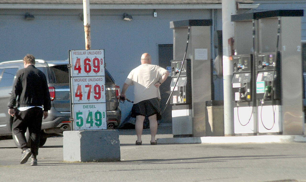 A customer fills his tank on Saturday at Grandview Grocery in Port Angeles as gasoline prices creep higher across the region. (Keith Thorpe/Peninsula Daily News)