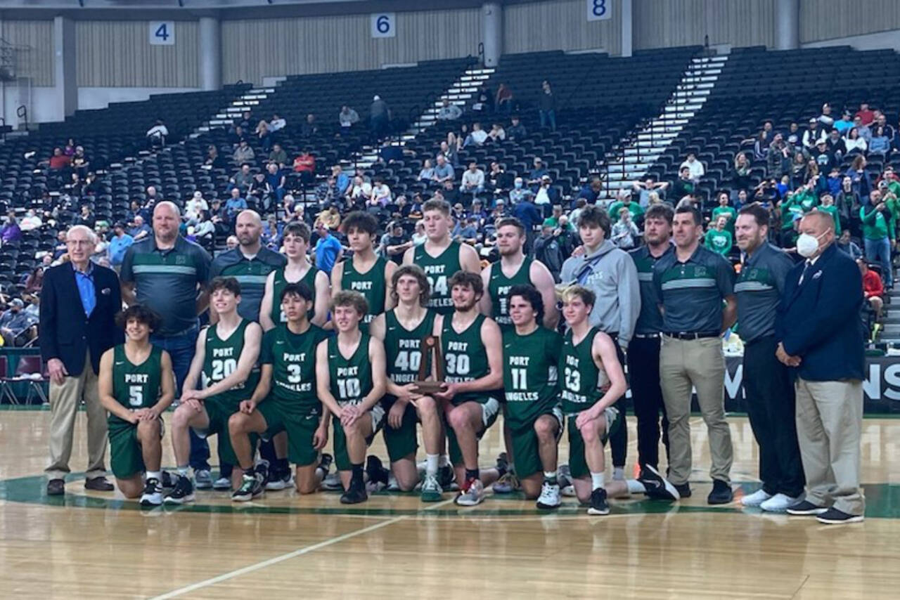 Port Angeles poses with the Class 2A Boys Basketball Tournament's sixth-place trophy at the Yakima Valley SunDome on Saturday. The Roughriders finished 20-8 on the season, won a share of the Olympic League title and earned their first trophy at state since 1997.