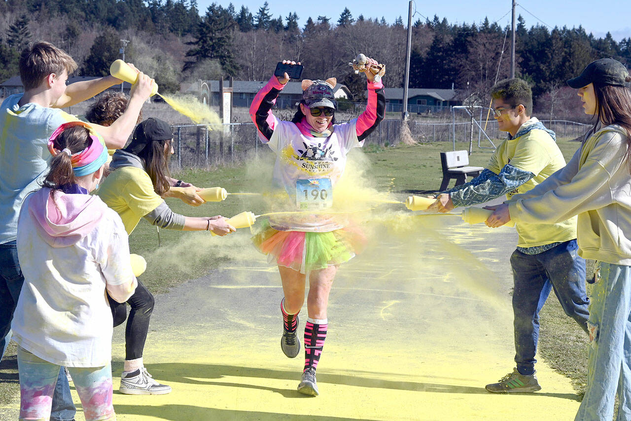 Michael Dashiell/Olympic Peninsula News Group
Tiffanie Powless gets a splash of yellow at the last color station at the Sun Fun Color Run 5k Saturday morning at the Albert Haller Playfields just north of Carrie Blake Community Park in Sequim. More than 500 participants were registered to run/walk 5k and 1k races, which were among the events offered during the third annual Sunshine Festival on Friday and Saturday.