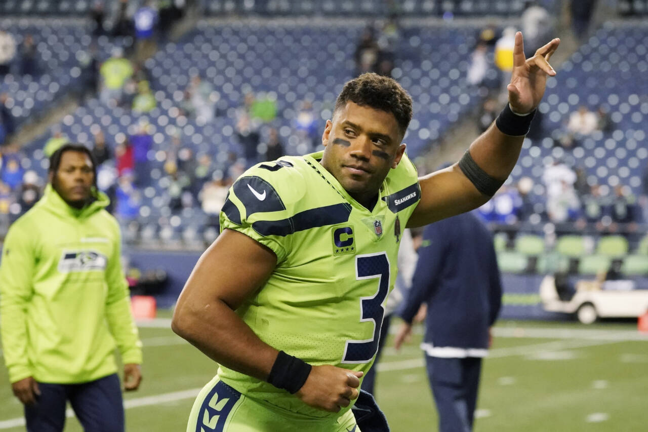 Seattle Seahawks quarterback Russell Wilson waves to fans as he leaves the field after an NFL football game against the Los Angeles Rams on Oct. 7, 2021, in Seattle. The Seattle Seahawks have agreed to trade nine-time Pro Bowl quarterback Wilson to the Denver Broncos for a massive haul of draft picks and players, pending Wilson passing a physical. (Elaine Thompson/The Associated Press)
