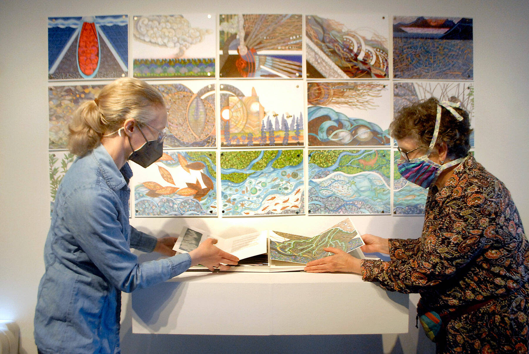 Gallery director Sarah Jane, left, and exhibit co-curator Lucia Harrison of Tacoma arrange a display that will be included in the exhibition “Science Stories: A Collaboration of Book Artists and Scientists,” which opens Friday at the Port Angeles Fine Arts Center. (Keith Thorpe/Peninsula Daily News)