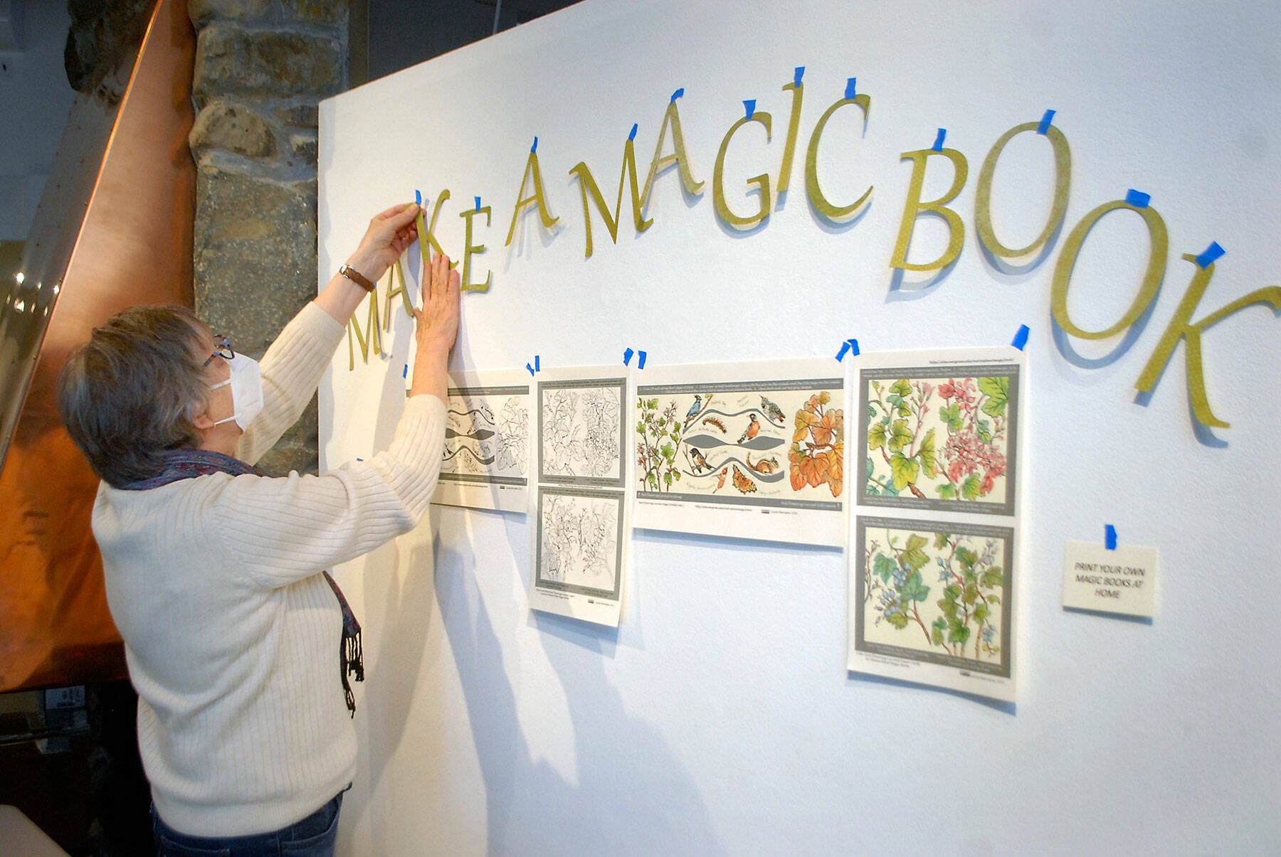 An Gates of Tacoma sets up a book-making exhibit that will be part of “Science Stories: A Collaboration of Book Artists and Scientists,” which opens on Friday at the Port Angeles Fine Arts Center. (Keith Thorpe/Peninsula Daily News)