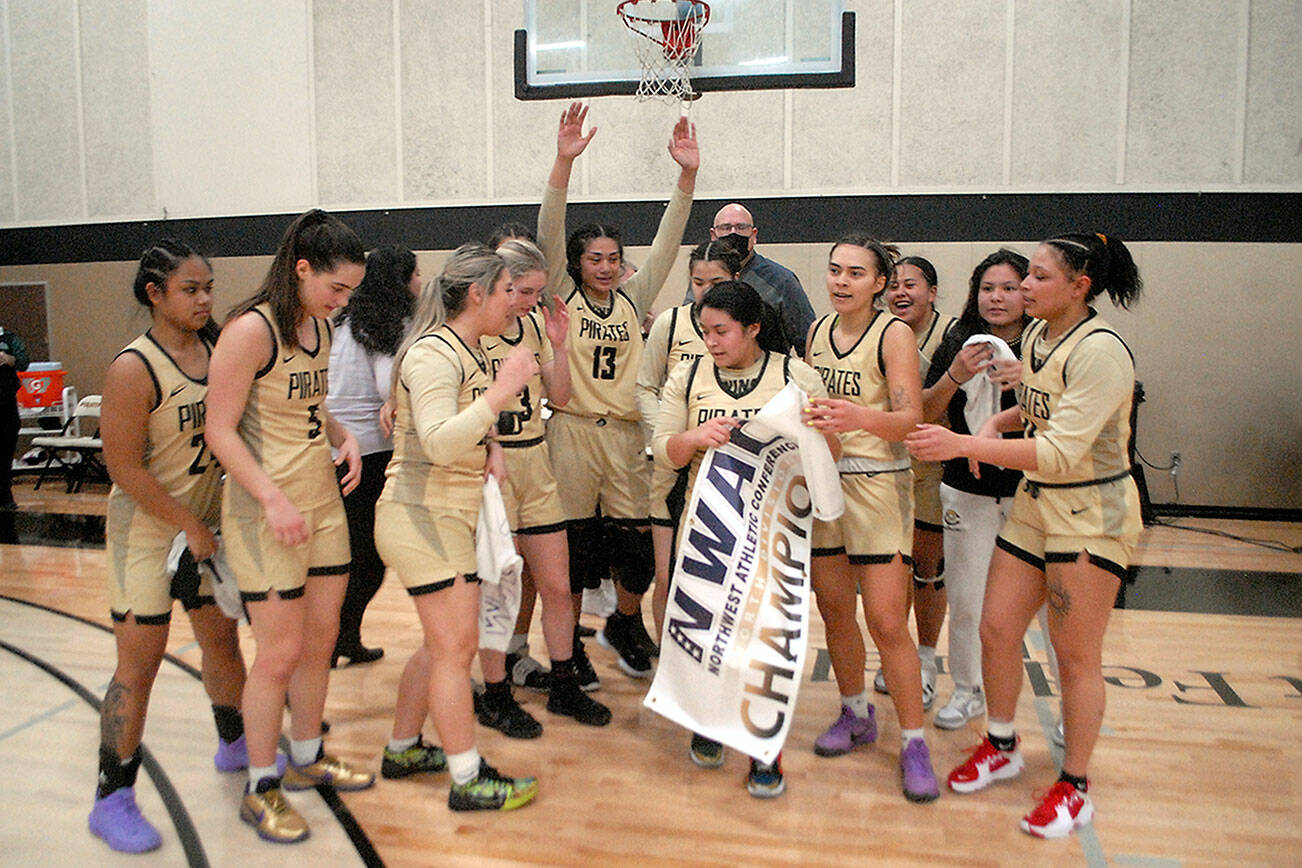 Keith Thorpe/Peninsula Daily News
Members of the Peninsula College womens basketball team celebrate Wednesday's 67-61 win over Shoreline to earn them the NWAC North Region championship. Holding the banner was Ariyanna Camacho-Villafuerte.