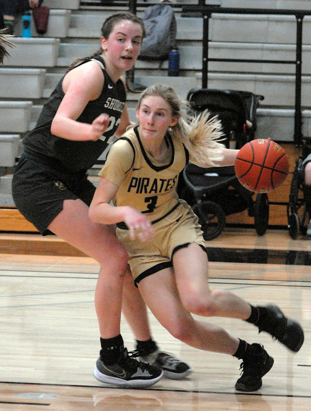 Peninsula’s Millie Long, right, drives past the defense of Shoreline’s Symone Pease during Wednesday’s season finale in Port Angeles. (Keith Thorpe/Peninsula Daily News)