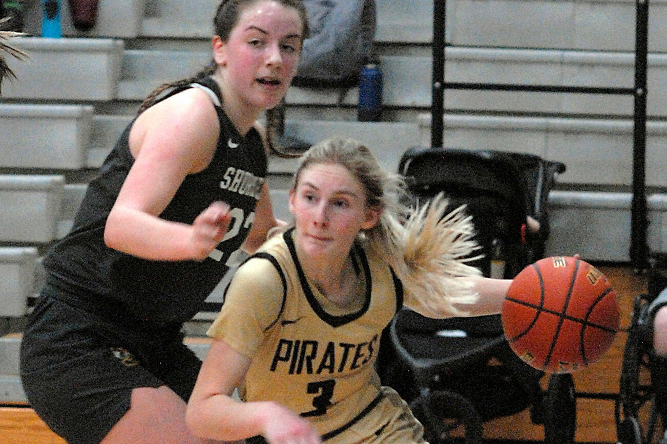 Keith Thorpe/Peninsula Daily News
Peninsula's Millie Long, right, drives past the defense of Shoreline's Symone Pease during Wednesday's season finale in Port Angeles. Long sprained her ankle in this game and the Pirates hope to have her back for the NWAC tournament that begins Saturday.