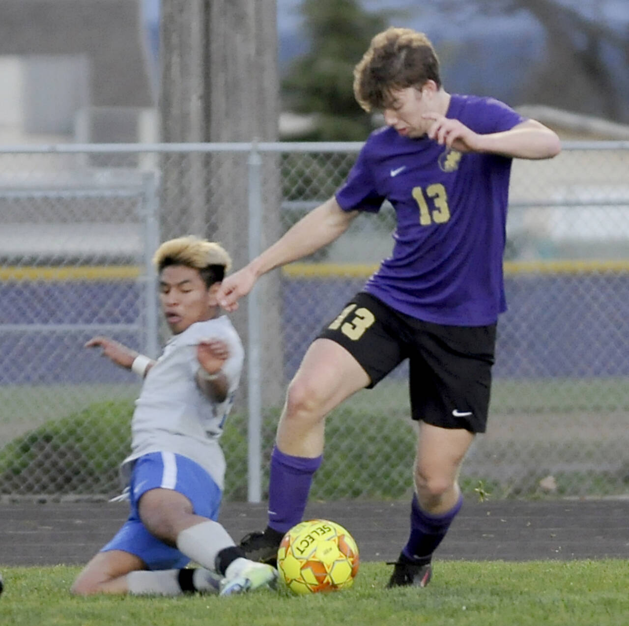 Sequim’s Brandon Charters battles for the ball with a North Mason defender in the Wolves’ 4-0 win Tuesday night in Sequim. (Michael Dashiell/Olympic Peninsula News Group)