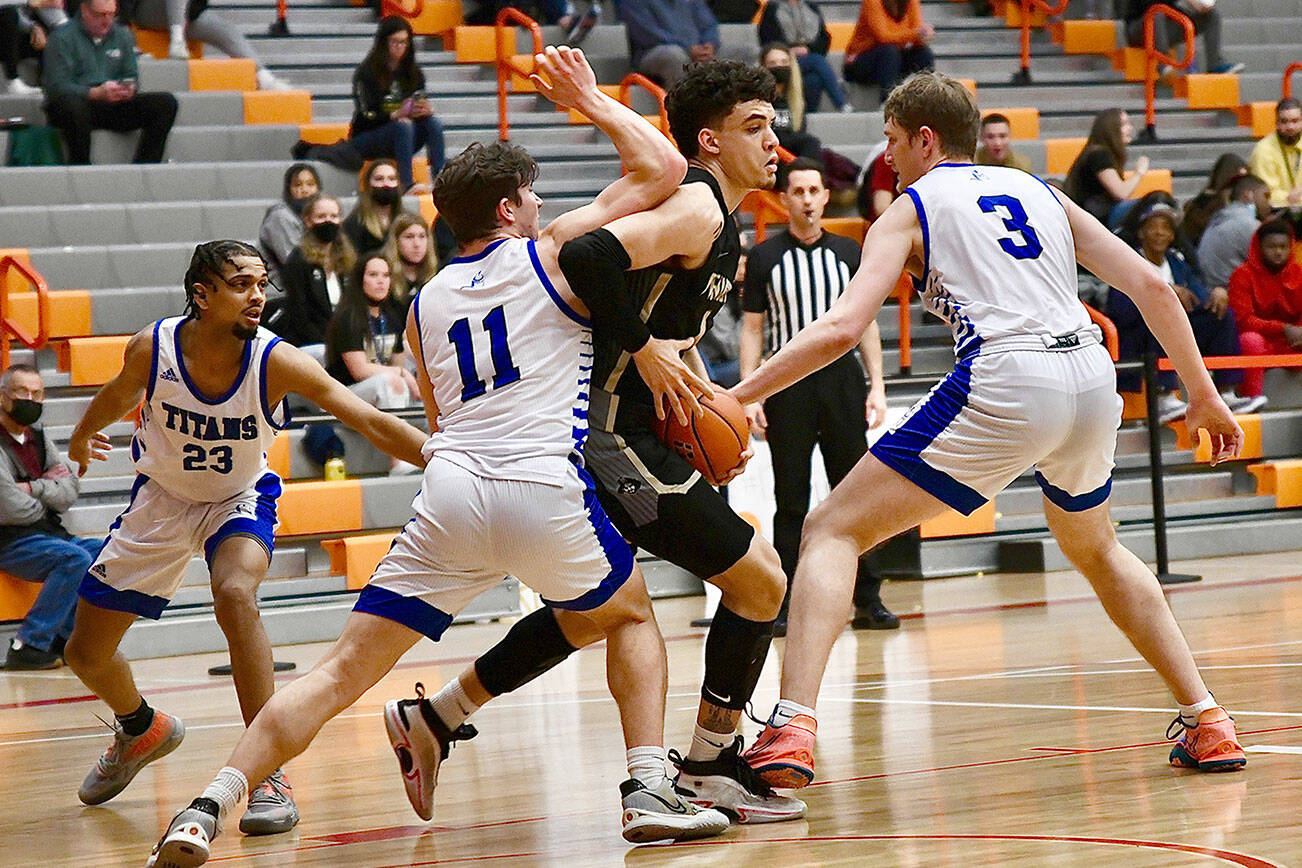 Peninsula College’s KeAndre Hunter-Holiday, center, is swarmed by Lane Titans defenders during the Pirates’ 82-68 NWAC Tournament loss on Thursday at Everett Community College. (Jay Cline/Peninsula College Athletics)