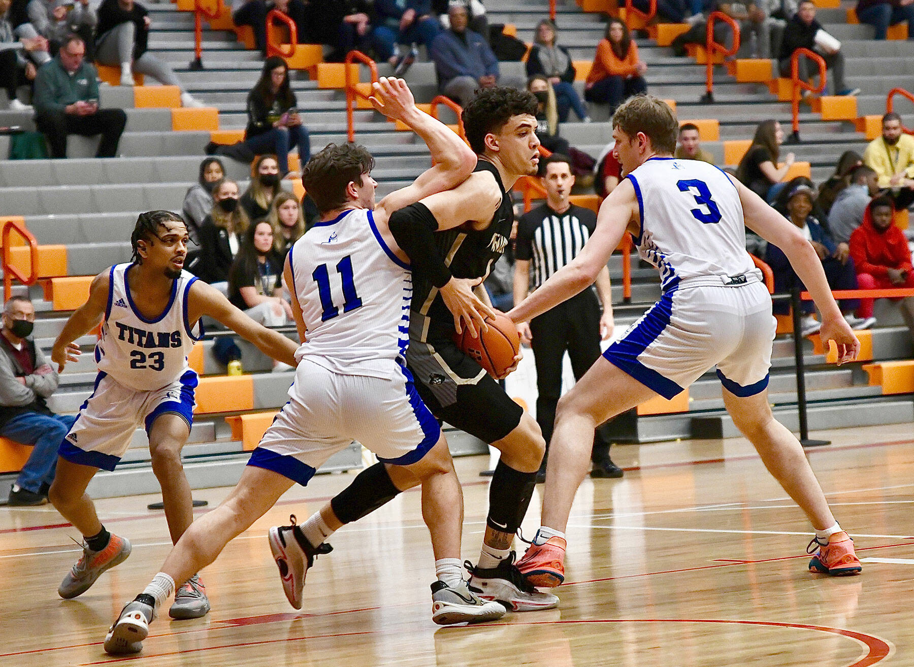 Peninsula College’s KeAndre Hunter-Holiday, center, is swarmed by Lane Titans defenders during the Pirates’ 82-68 NWAC Tournament loss on Thursday at Everett Community College. (Jay Cline/Peninsula College Athletics)