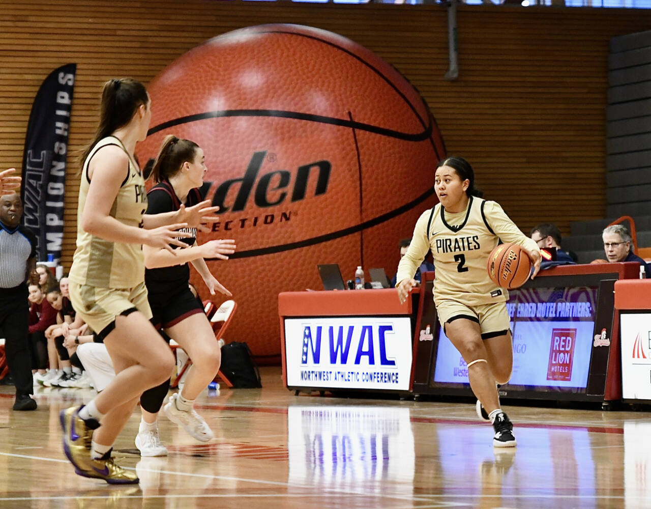 Jay Cline/Peninsula College Athletics
Peninsula College's Tatianna Kamae (2) brings the ball up the court against North Idaho in the Pirates' 56-48 win in the opening round of the NWAC Tournament held in Everett. At left is Hope Glasser.