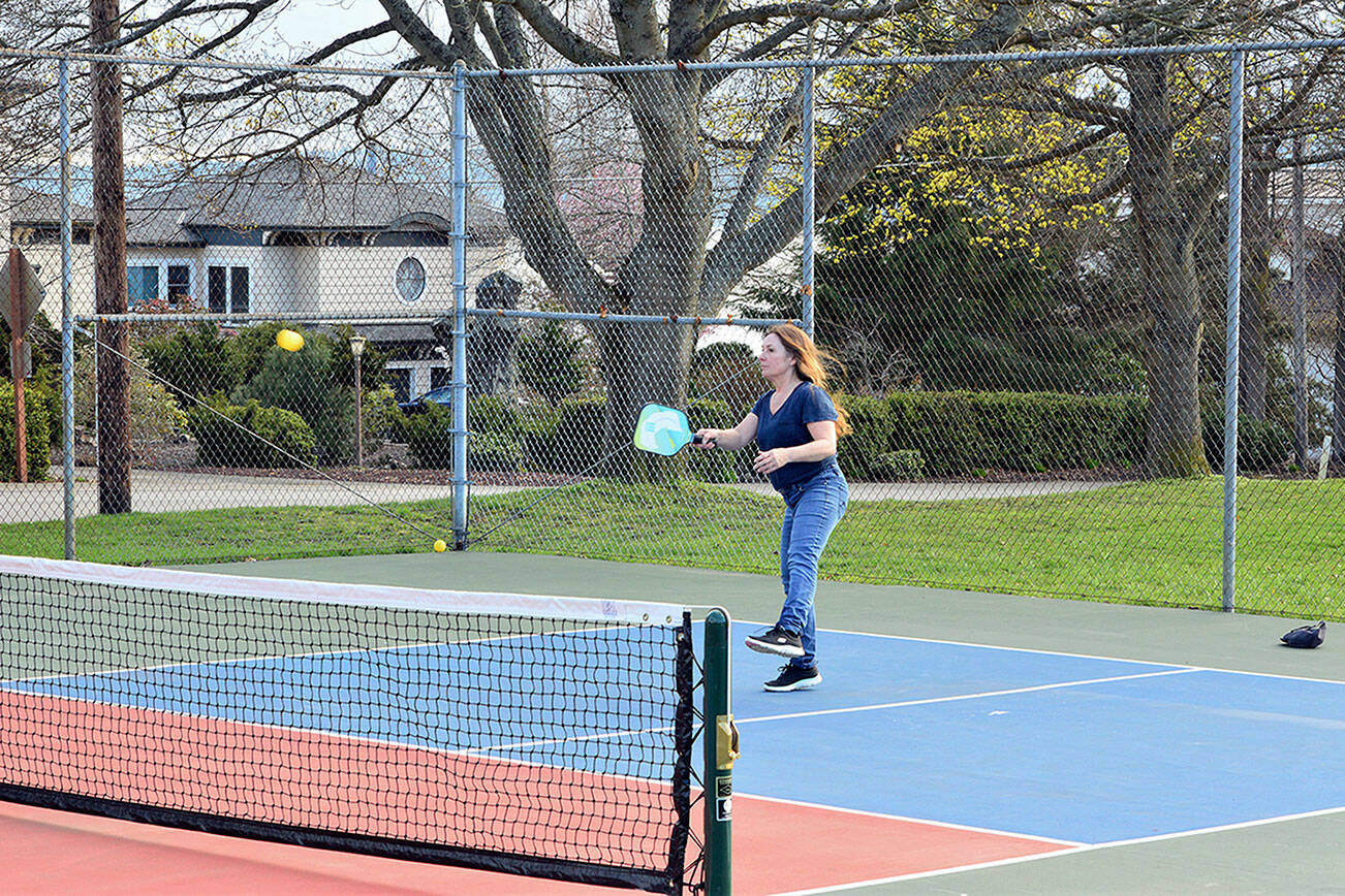 Susan Willis of Port Townsend, a relatively new pickleball player, takes command of her side of the court Tuesday evening. (Diane Urbani de la Paz/Peninsula Daily News)