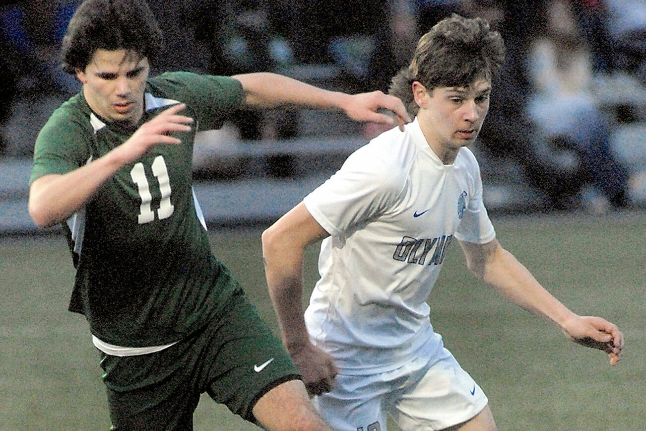 Keith Thorpe/Peninsula Daily News
Port Angeles' Xander Maestas, left, dribbles past Olympic's Justin Thorsen on Thursday evening at Peninsula College in Port Angeles.