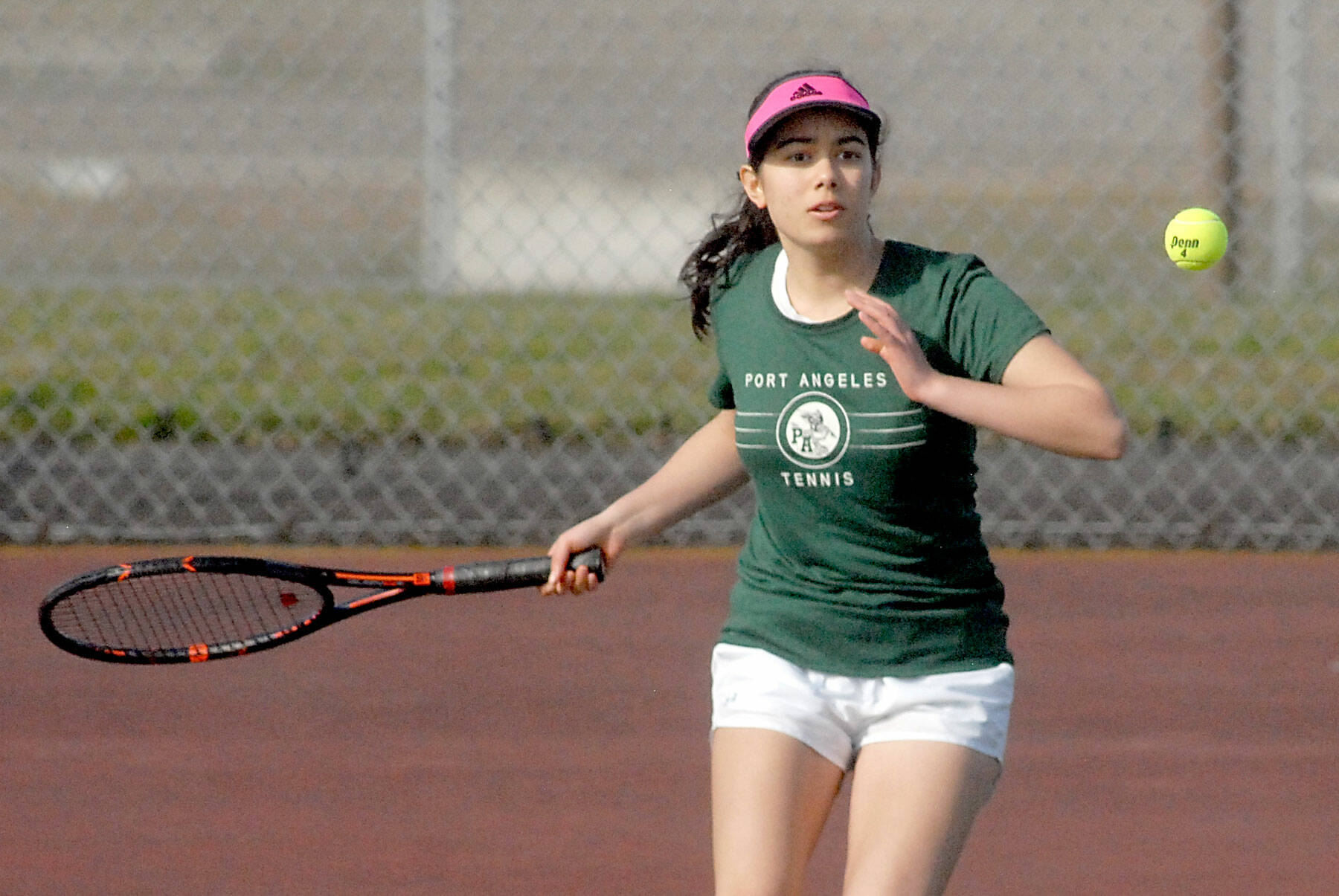 Port Angeles’ Liberty Lauer approches the ball in her singles match on Thursday against North Kitsap’s Teegan DeVries at Port Angeles High School. (Keith Thorpe/Peninsula Daily News)