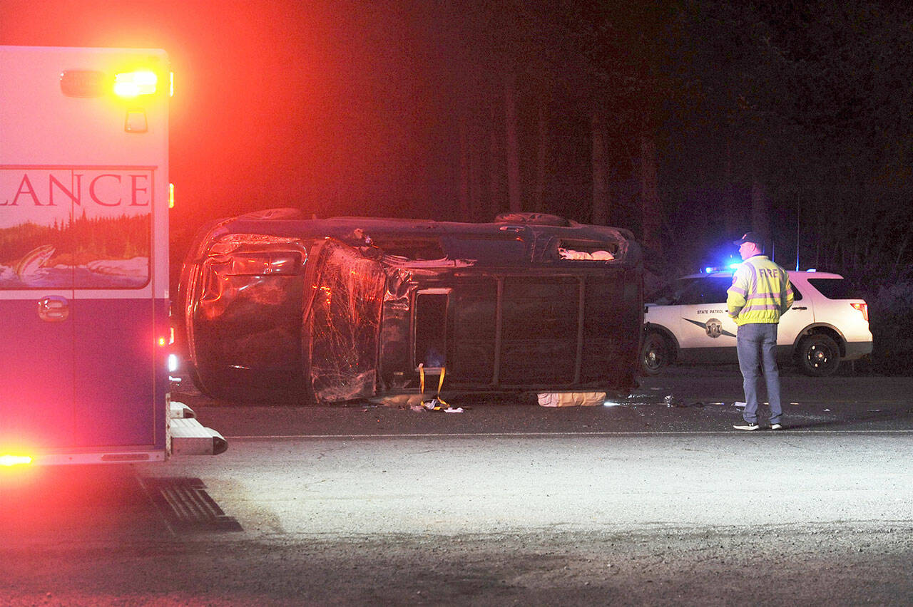 Minor injuries were reported after a wreck at the intersection at U.S. Highway 101 and state Highway 113 at about 6 a.m. Friday, said Trooper Brandon Johanson of the State Patrol. The trooper said that a car stopped at the Highway 113 stop sign, waiting to turn left onto northbound Highway 101. The driver did not see the SUV behind a boat being towed on Highway 101 and hit the SUV on its passenger side, causing it to roll/rotate before coming to rest on its driver side in the middle of the road, facing northbound, he said. A citation was issued for failure to yield the right-of-way, he said. (Lonnie Archibald/for Peninsula Daily News)