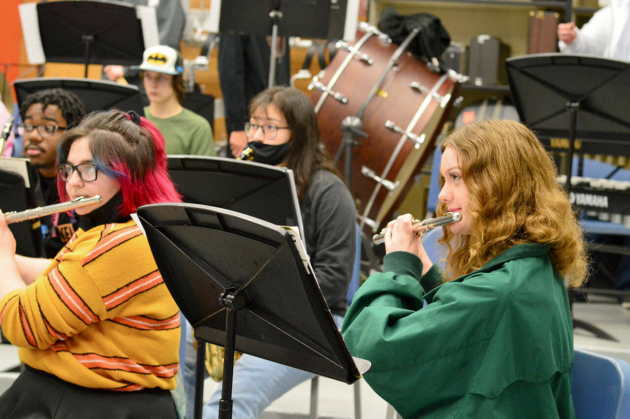 After many months of masking, flutists Gabby Mattern-Hall, left, and Sibyl Finman got to shed their face coverings for band practice earlier this month in George Rodes’ band room. (Diane Urbani de la Paz/Peninsula Daily News)