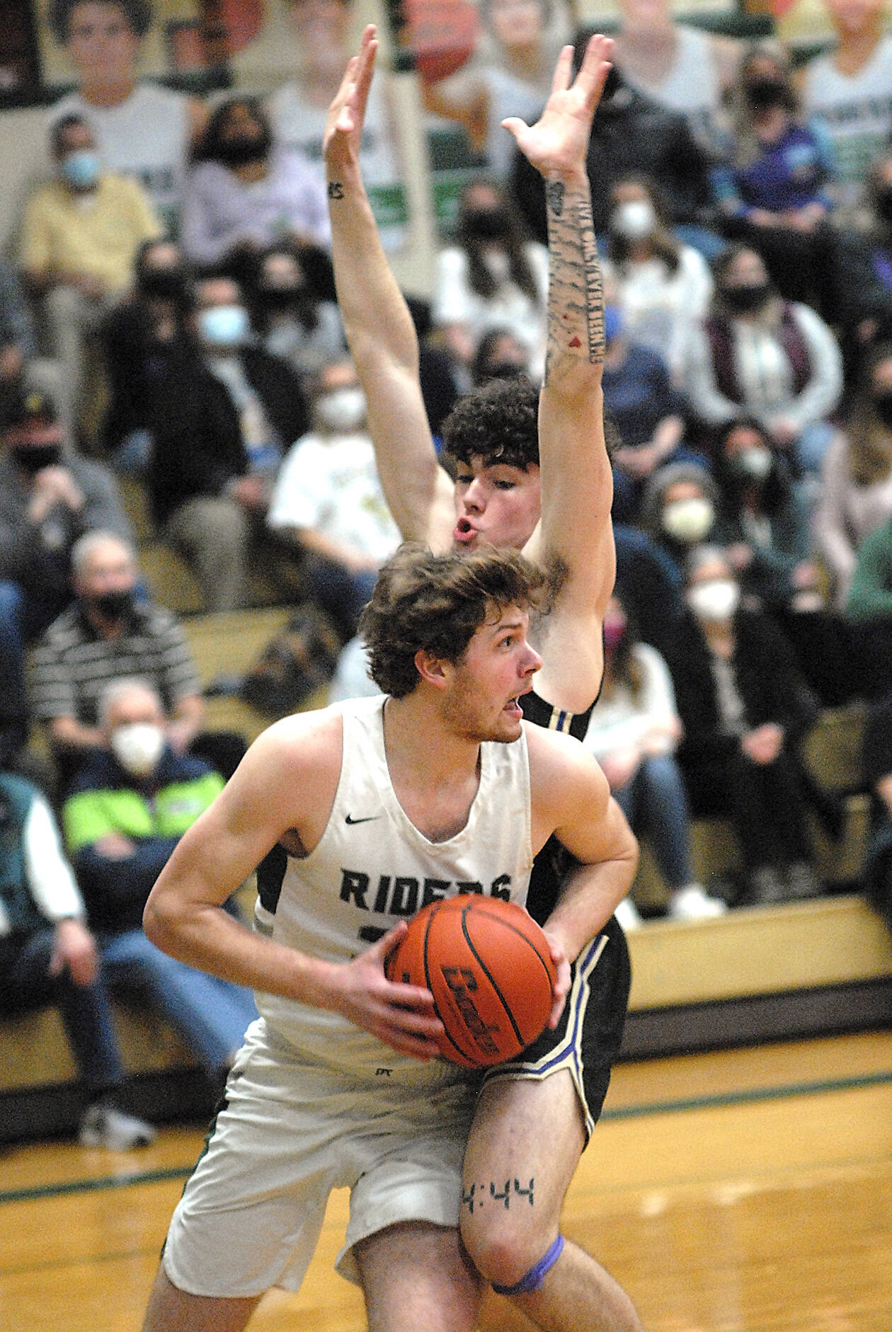 Keith Thorpe/Peninsula Daily News Port Angeles’ Wyatt Dunning, front, tries to evade the defense of North Kitsap’s Jonas La Tour during Thursday night’s game at Port Angeles High School.