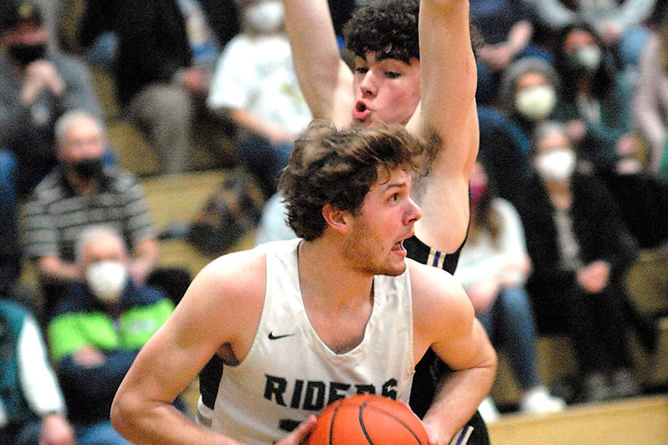 Keith Thorpe/Peninsula Daily News
Port Angeles' Wyatt Dunning, front, tries to evade the defense of North Kitsap's Jonas La Tour during Thursday night's game at Port Angeles High School.
