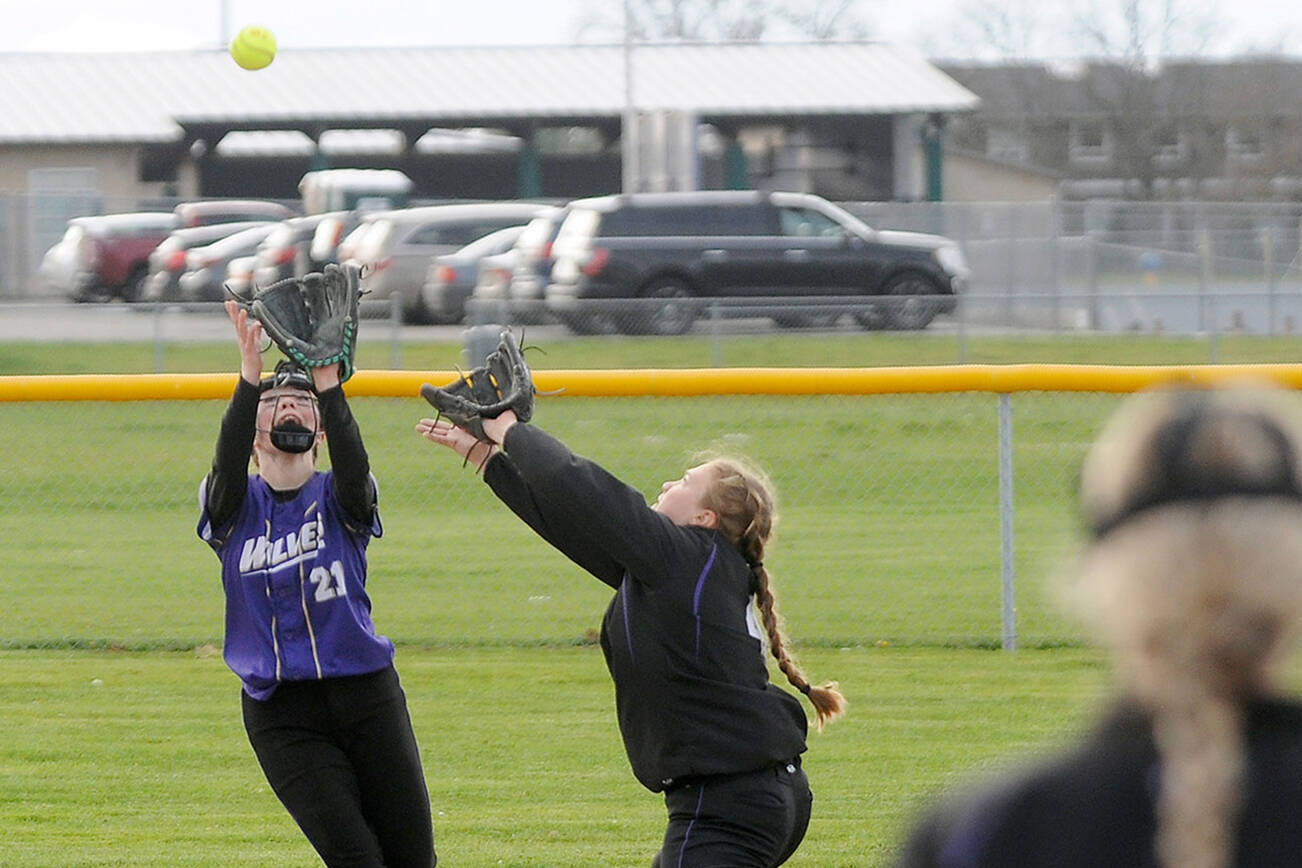 Michael Dashiell/Olympic Peninsula News Group
Sequim shortstop Hannah Bates, left, and second baseman Addie Smith converge on an infield fly ball during the Wolves' 8-6 loss to North Kitsap on Tuesday.