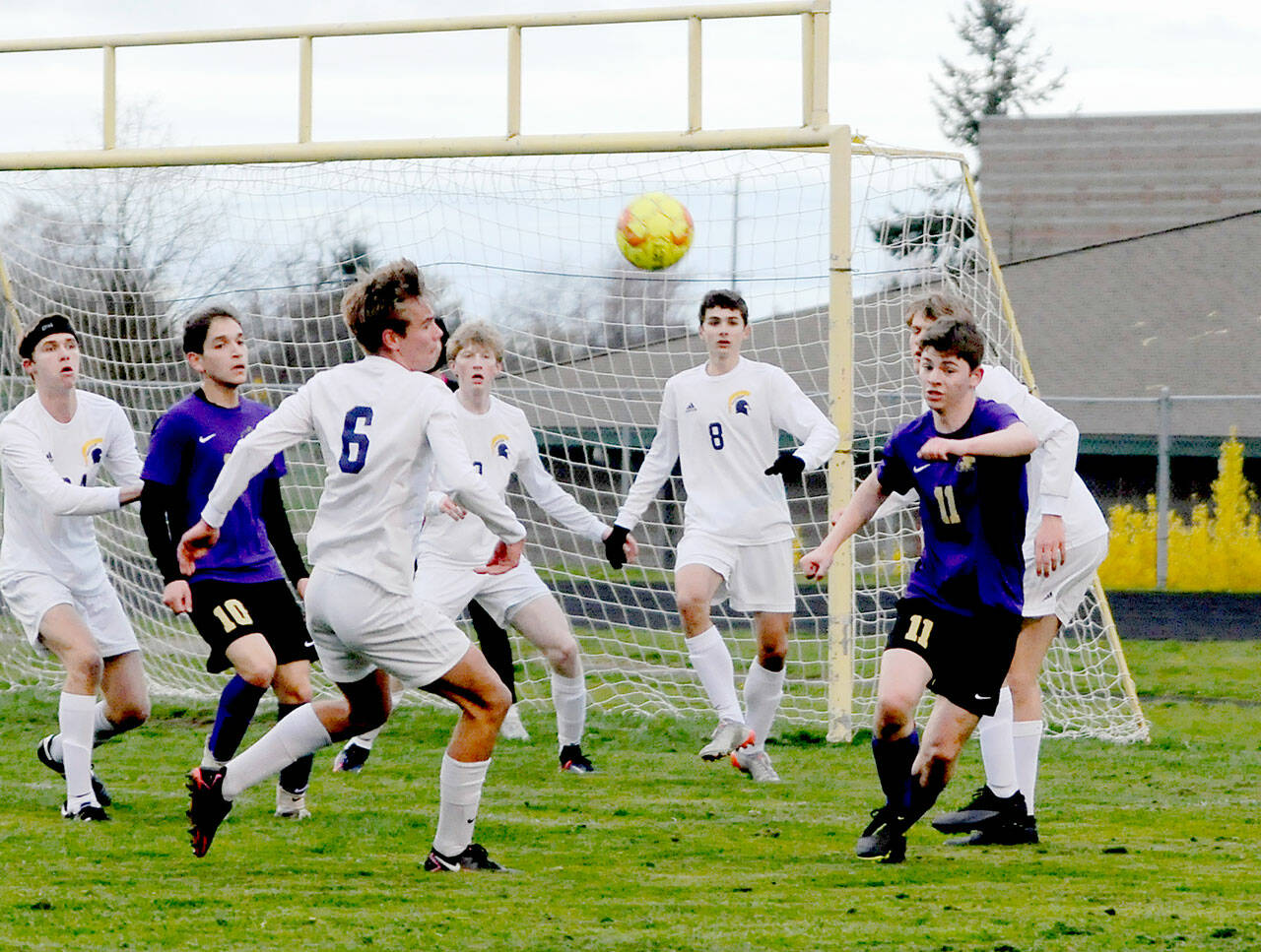 Sequims Ethan Knight, right, is surrounded by Bainbridge defenders near the Spartans goal box during the Wolves 3-0 loss on Tuesday. (Michael Dashiell/Olympic Peninsula News Group)