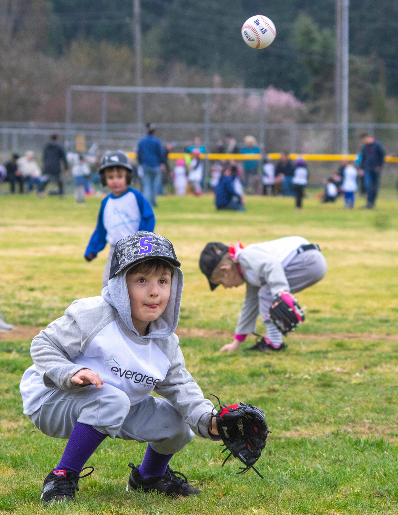 T-ball player Dominic Johnson tries for a catch during opening day of the 2022 Sequim Little League. (Emily Matthiessen/Olympic Peninsula News Group)