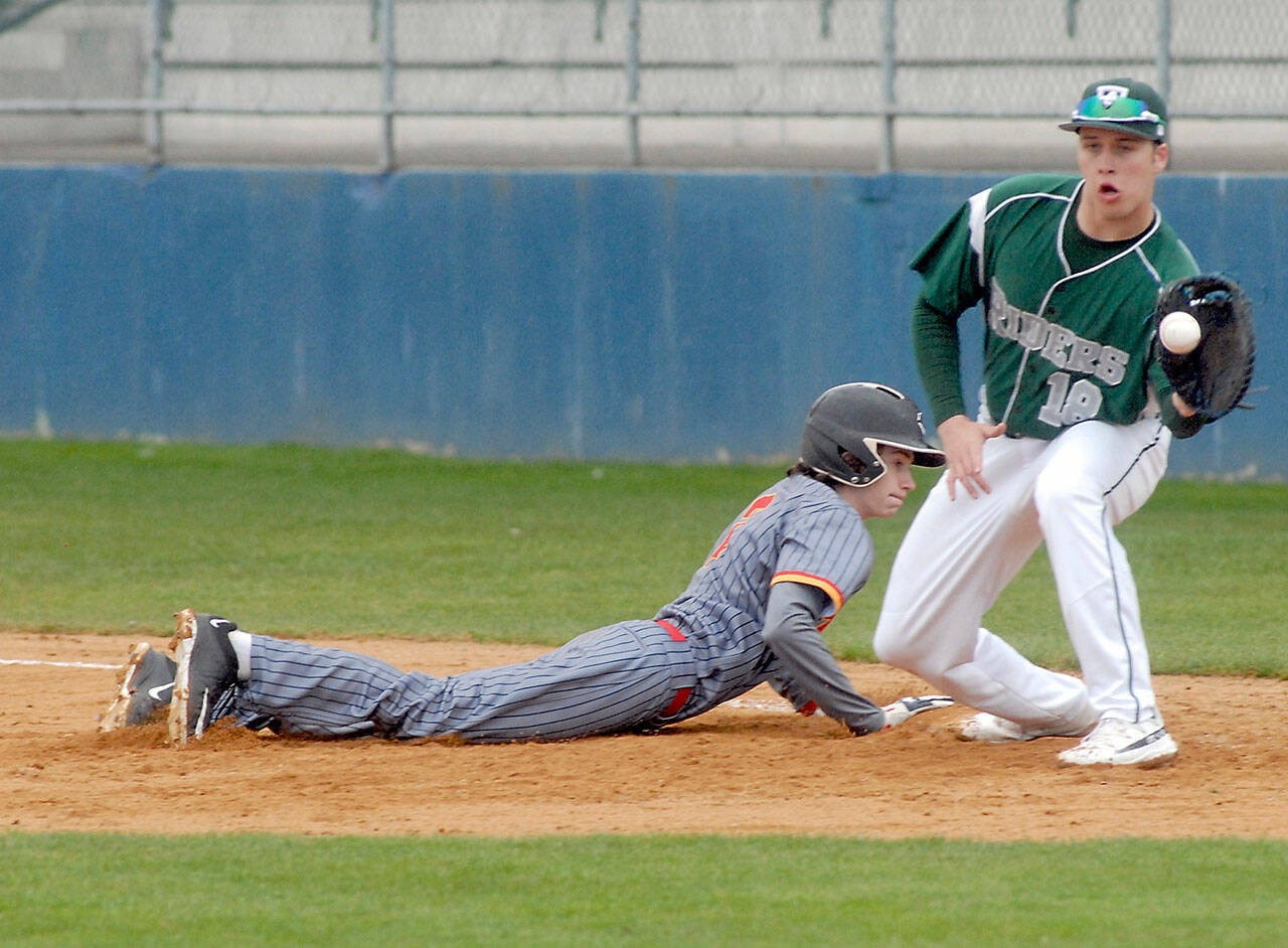 Port Angeles first baseman Cole Johnson receives the ball in an attempt to pick off Mt. Tahoma baserunner Robert Bailey on Friday afternoon in Port Angeles. (Keith Thorpe/Peninsula Daily News)